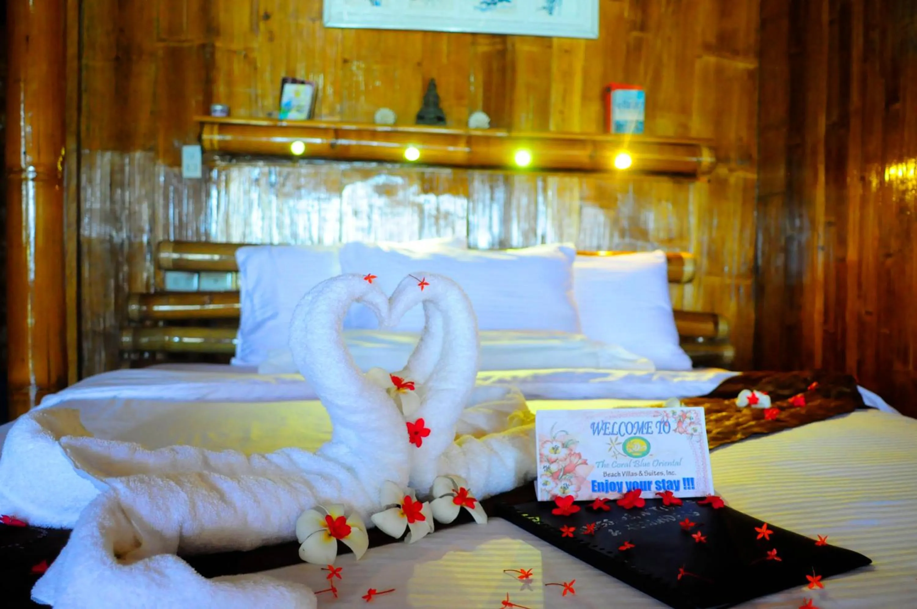 Bed in The Coral Blue Oriental Beach Villas and Suites