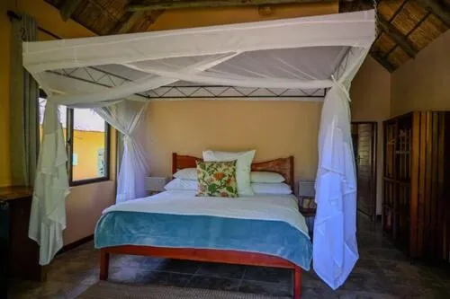 Bed in Maramba River Lodge