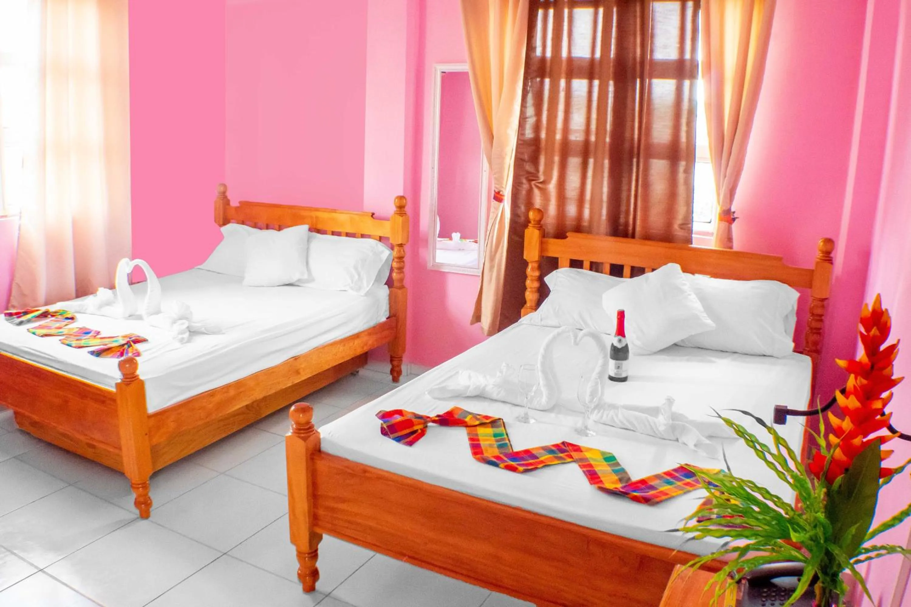 Bed in La Flamboyant Hotel