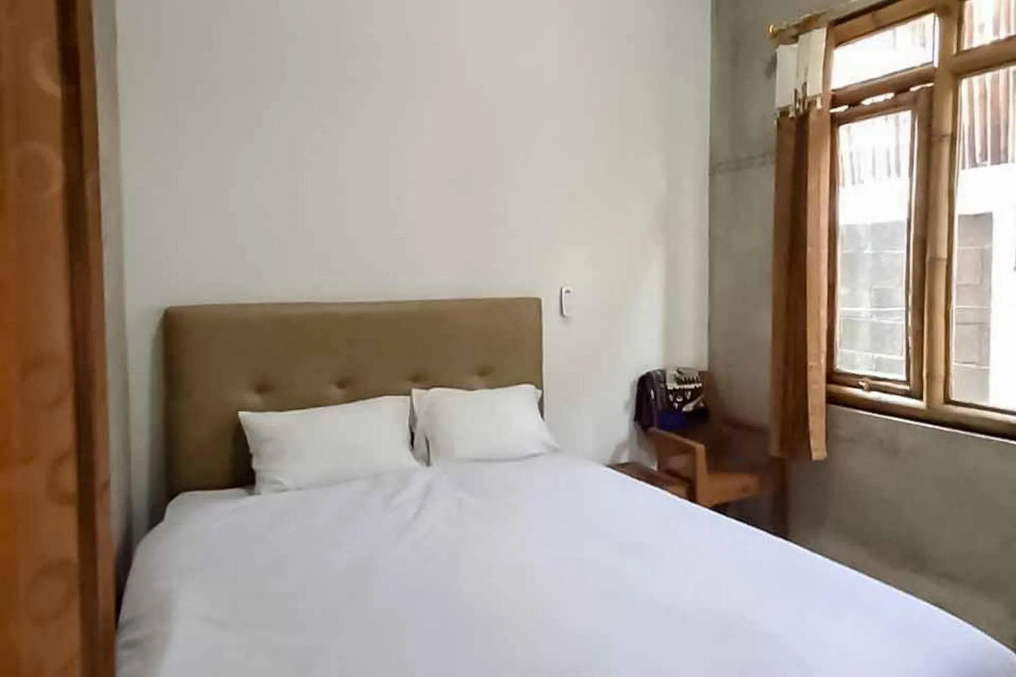 Bed in Sukawana Guest House Mitra RedDoorz