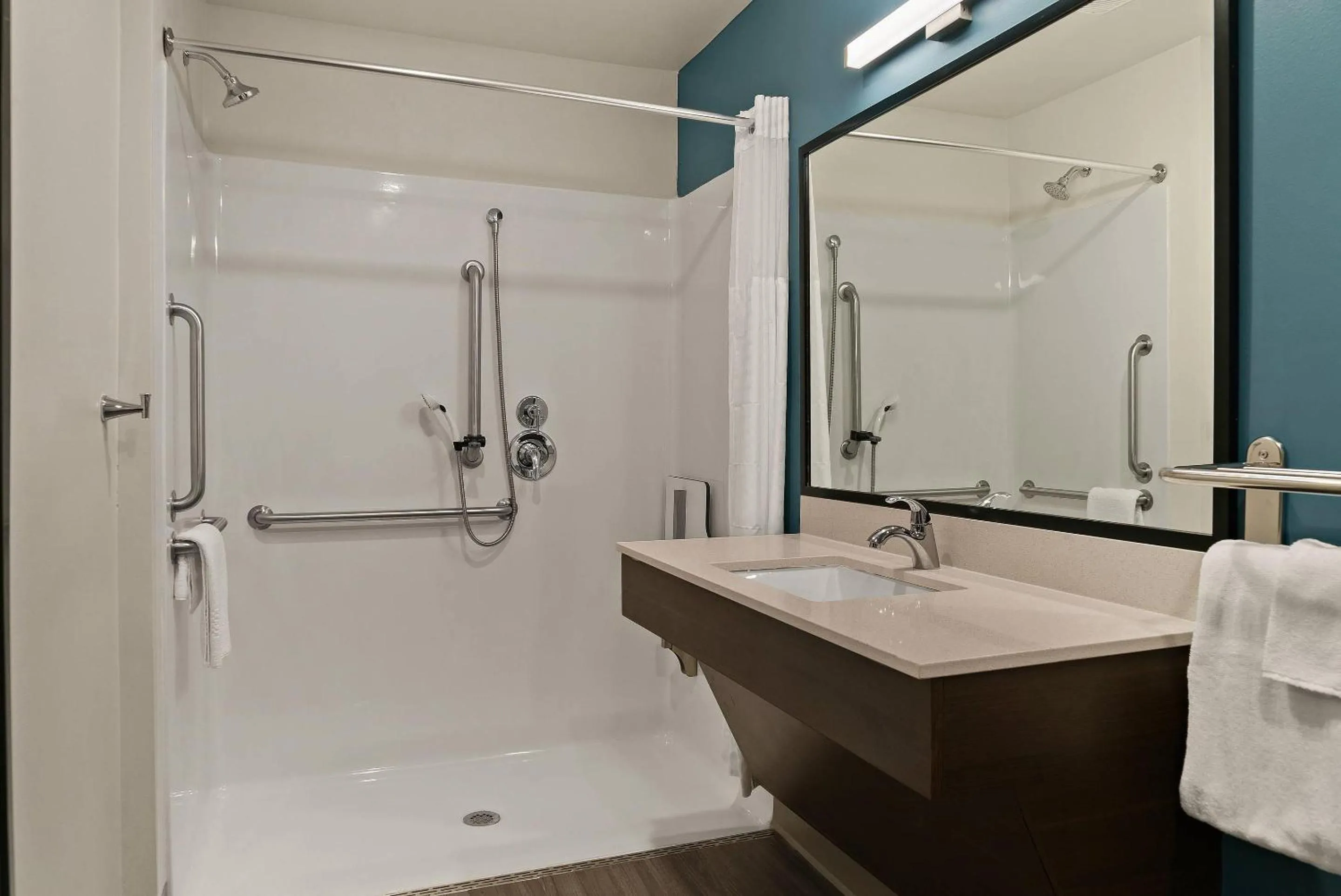 Bedroom in WoodSpring Suites East Lansing - University Area