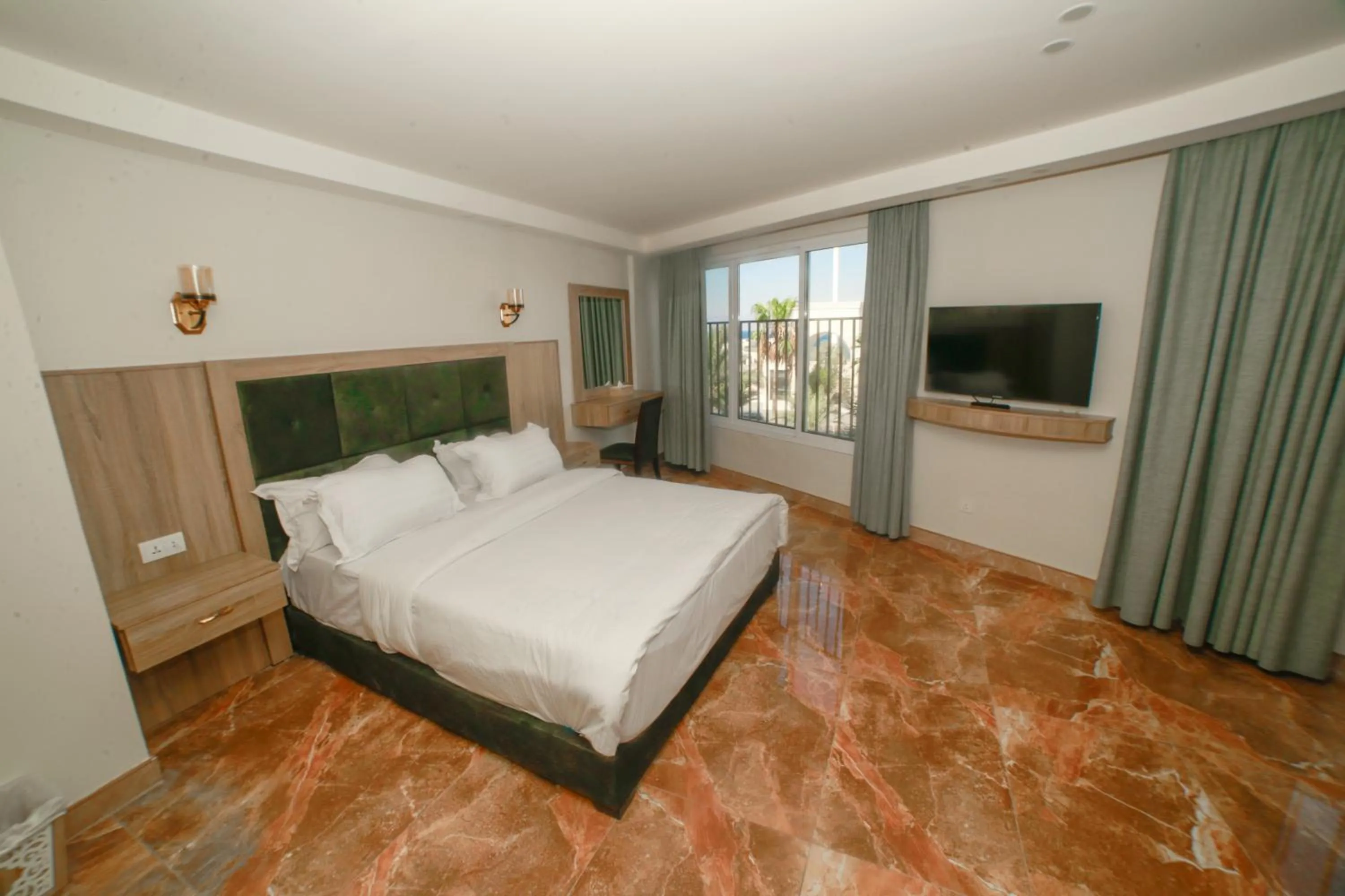 Communal lounge/ TV room, Bed in Yafko Hotel