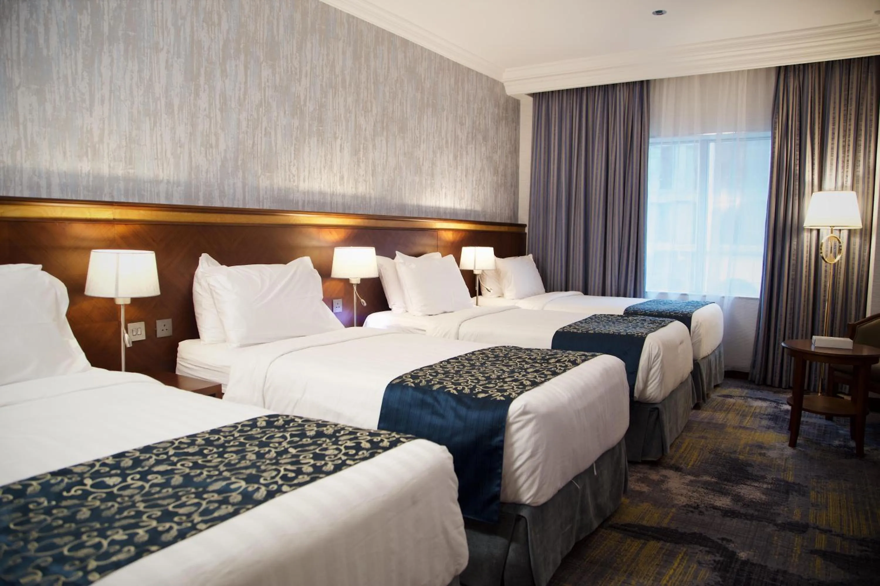 Bed in Nozol Royal Inn Hotel