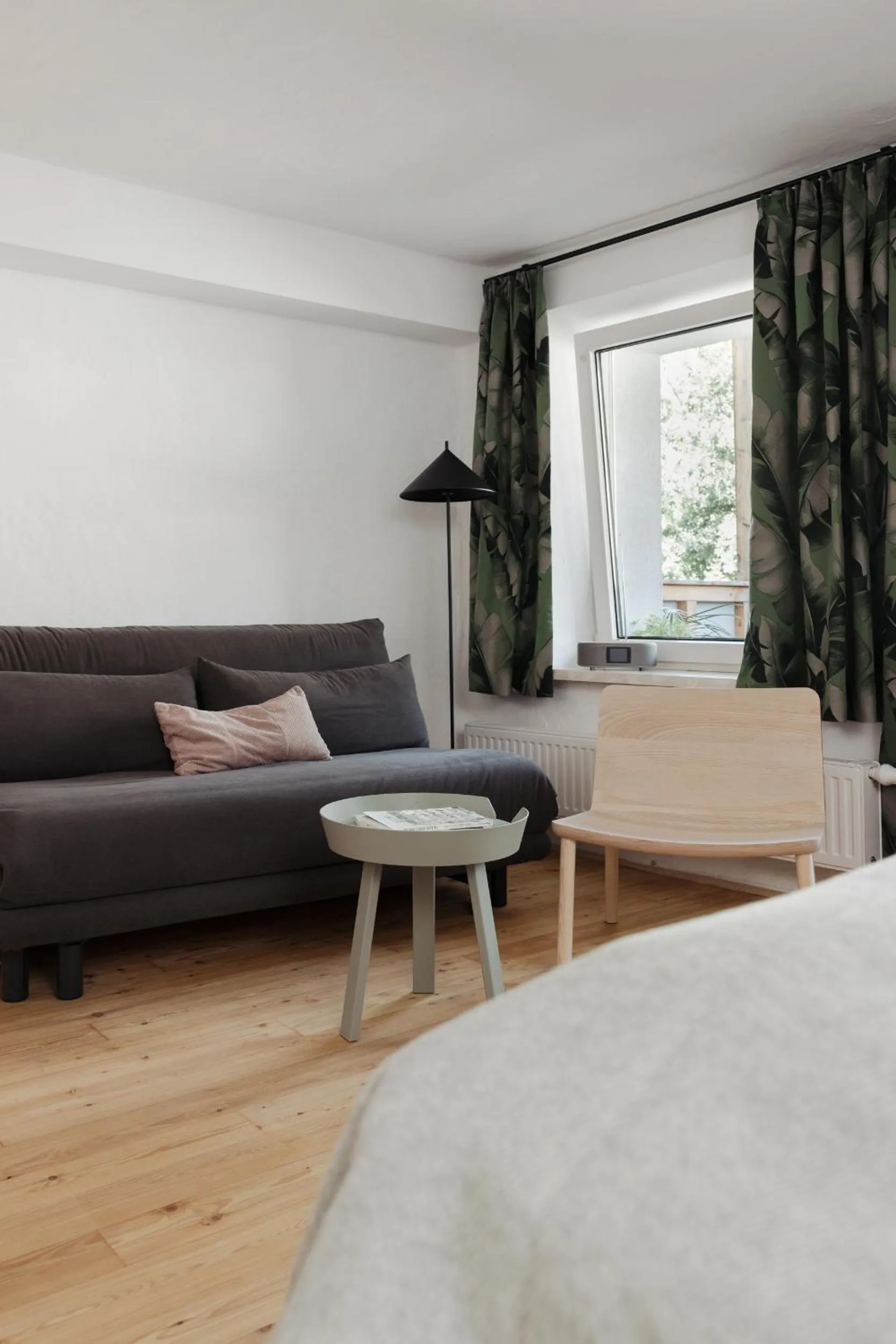 Seating area, Bed in Das Grüne Haus - Boutique Apartments ecofriendly