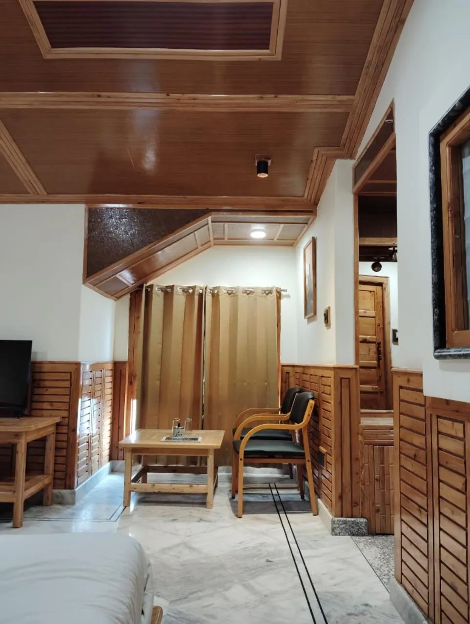 Seating area, Bed in Hotel CM Palace - Pure Vegetarian