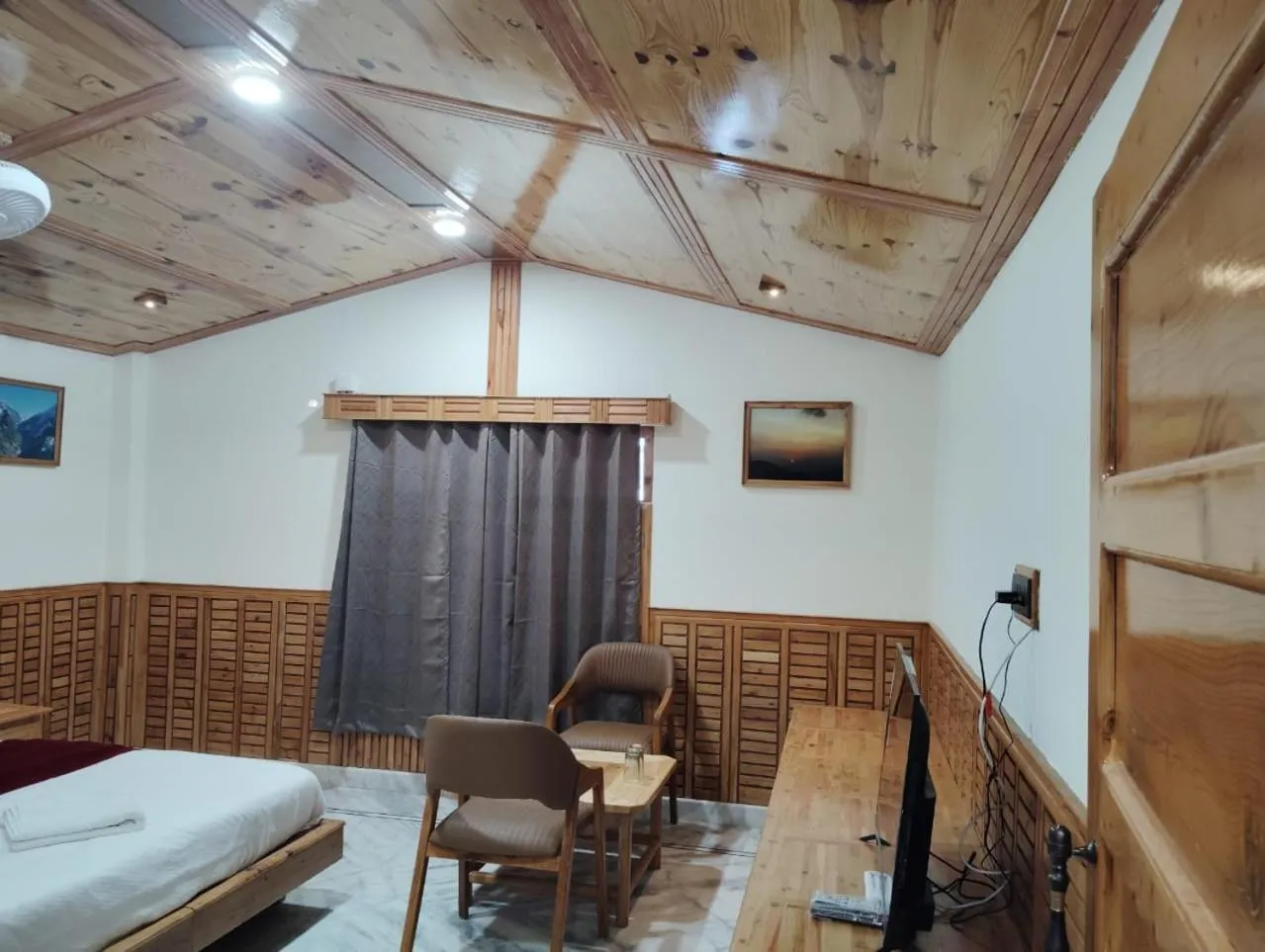 Seating area, Bed in Hotel CM Palace - Pure Vegetarian