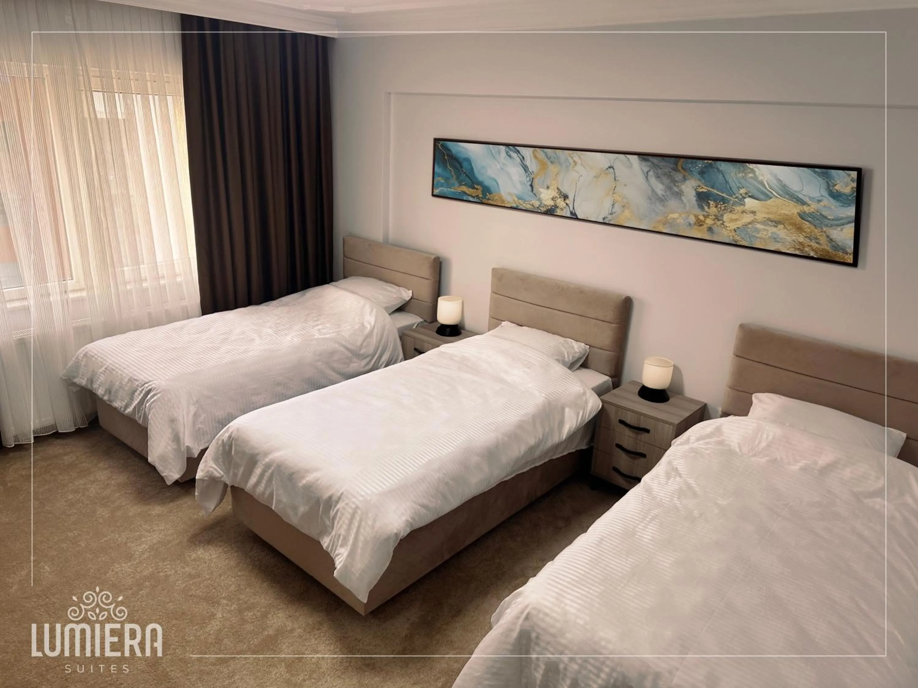 Bed in Lumiera Suites Hotel
