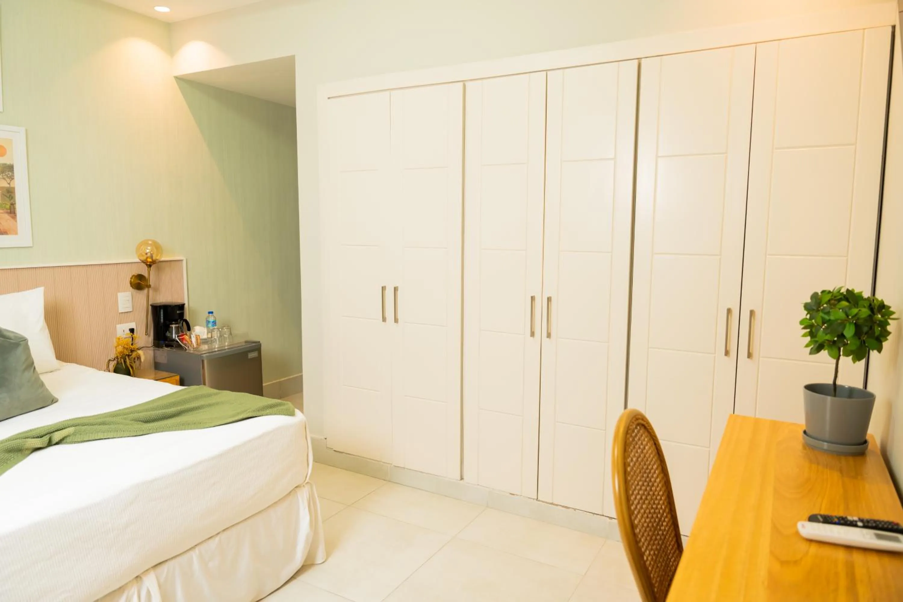 Bed in Hotel Stay Here Suites