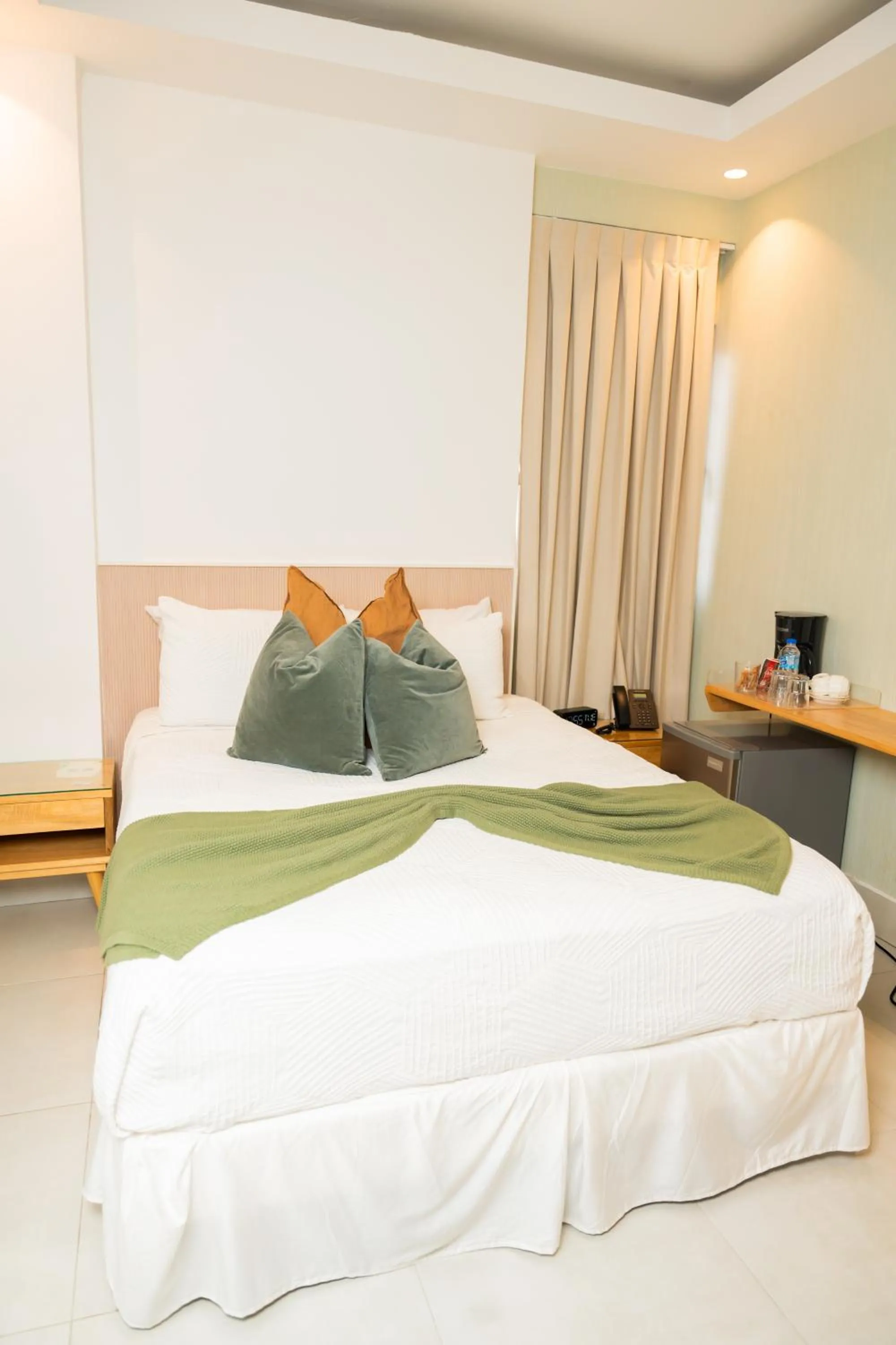 Bed in Hotel Stay Here Suites