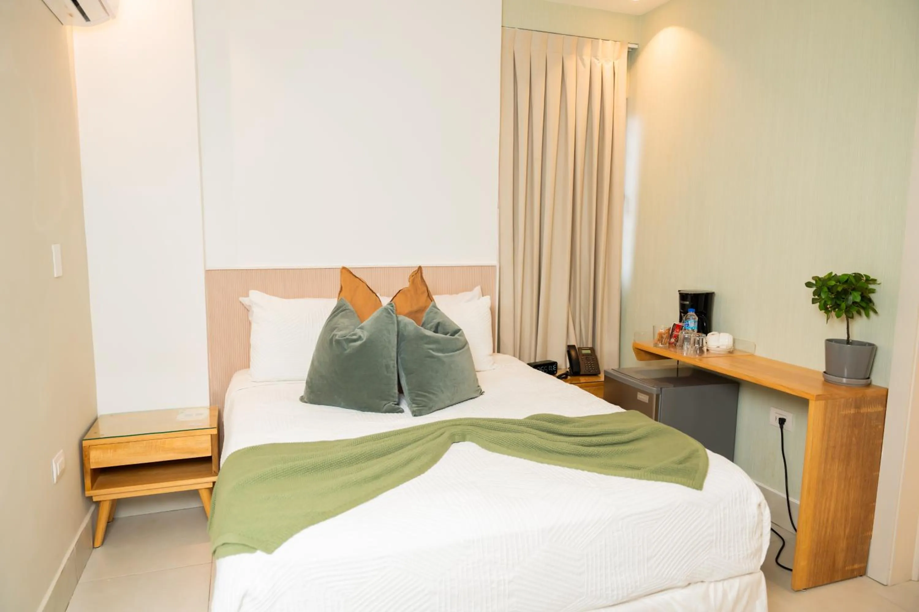 Bed in Hotel Stay Here Suites