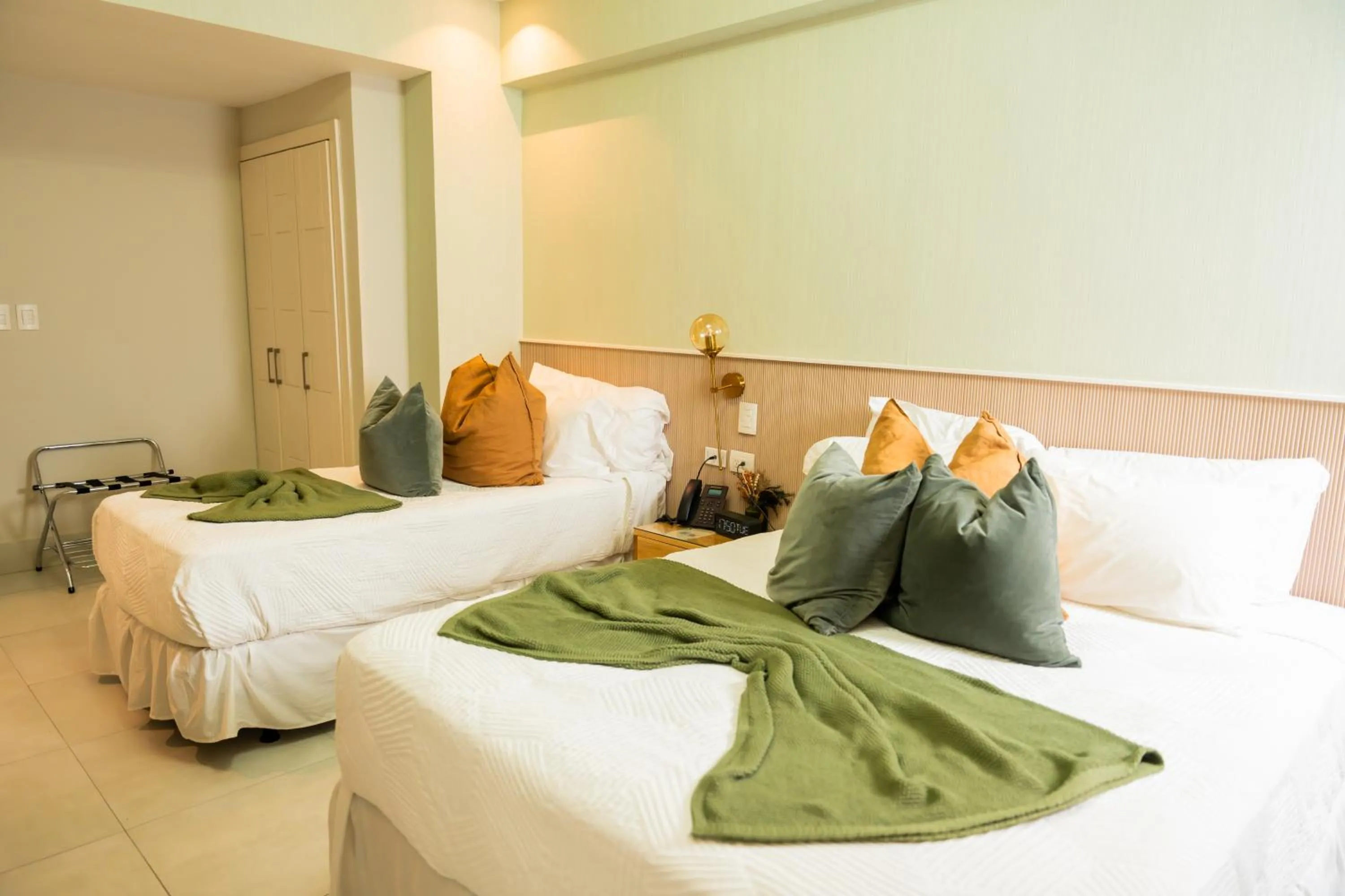 Bed in Hotel Stay Here Suites