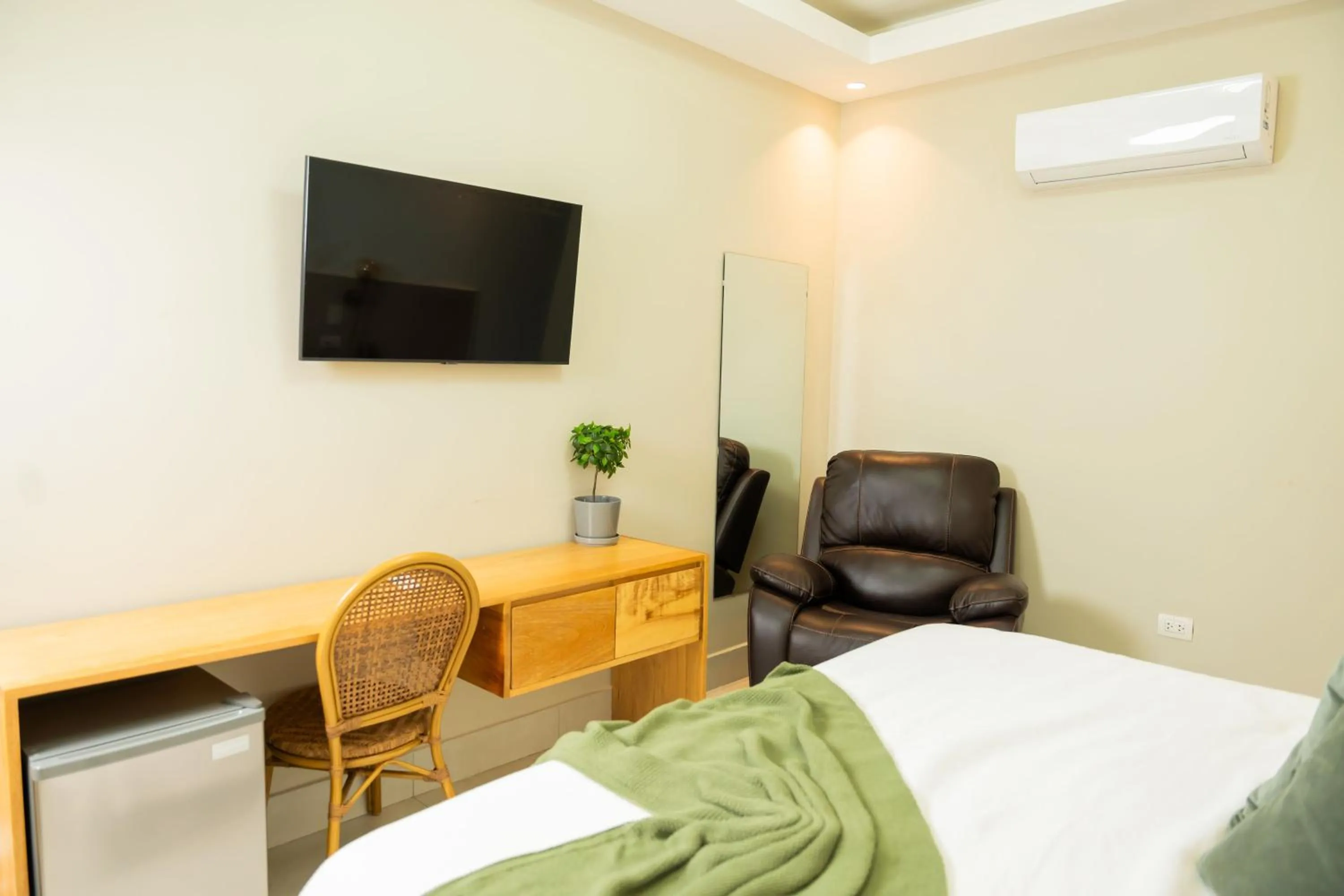 Bed in Hotel Stay Here Suites