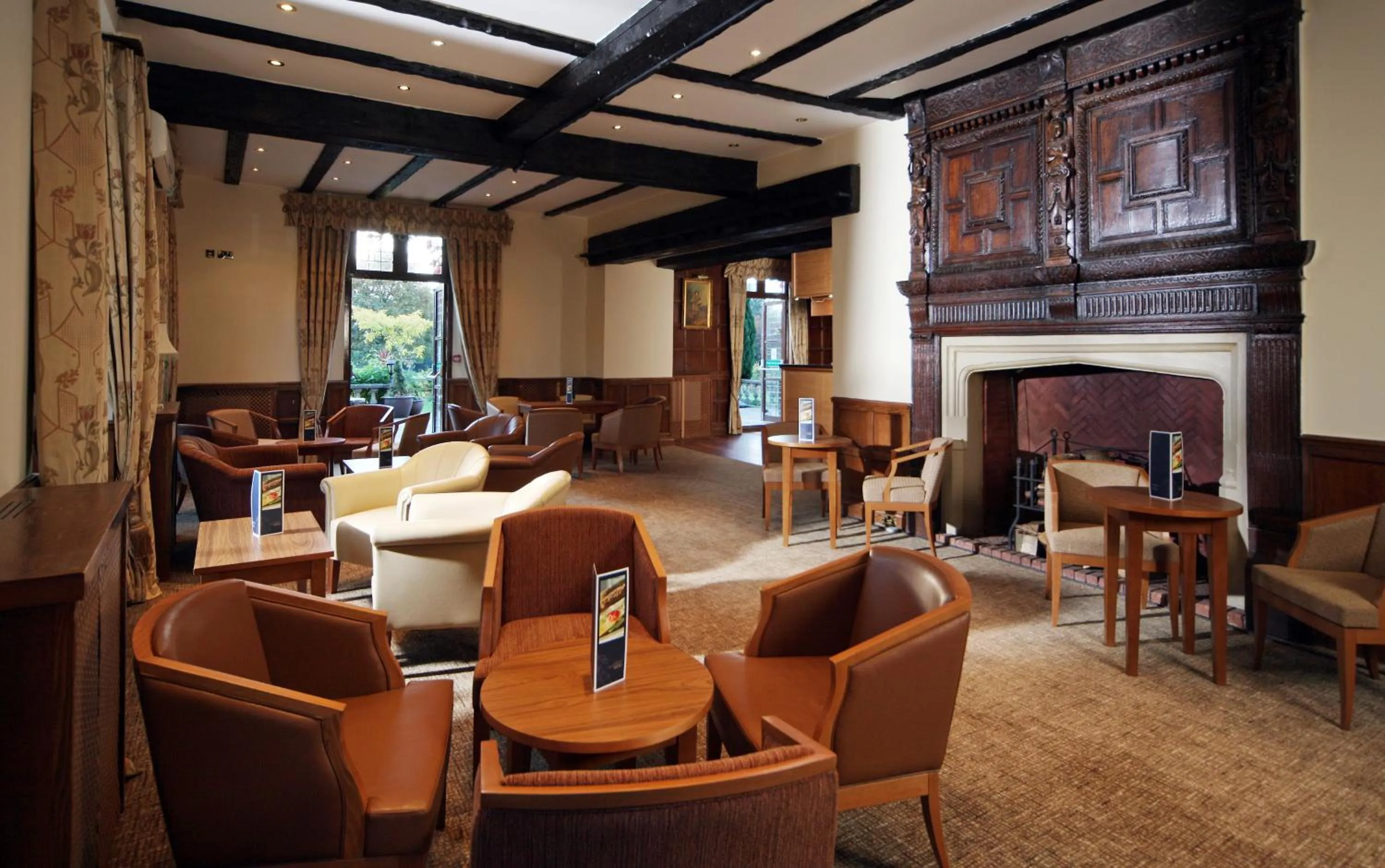 Communal lounge/ TV room in voco Letchworth Hall by IHG