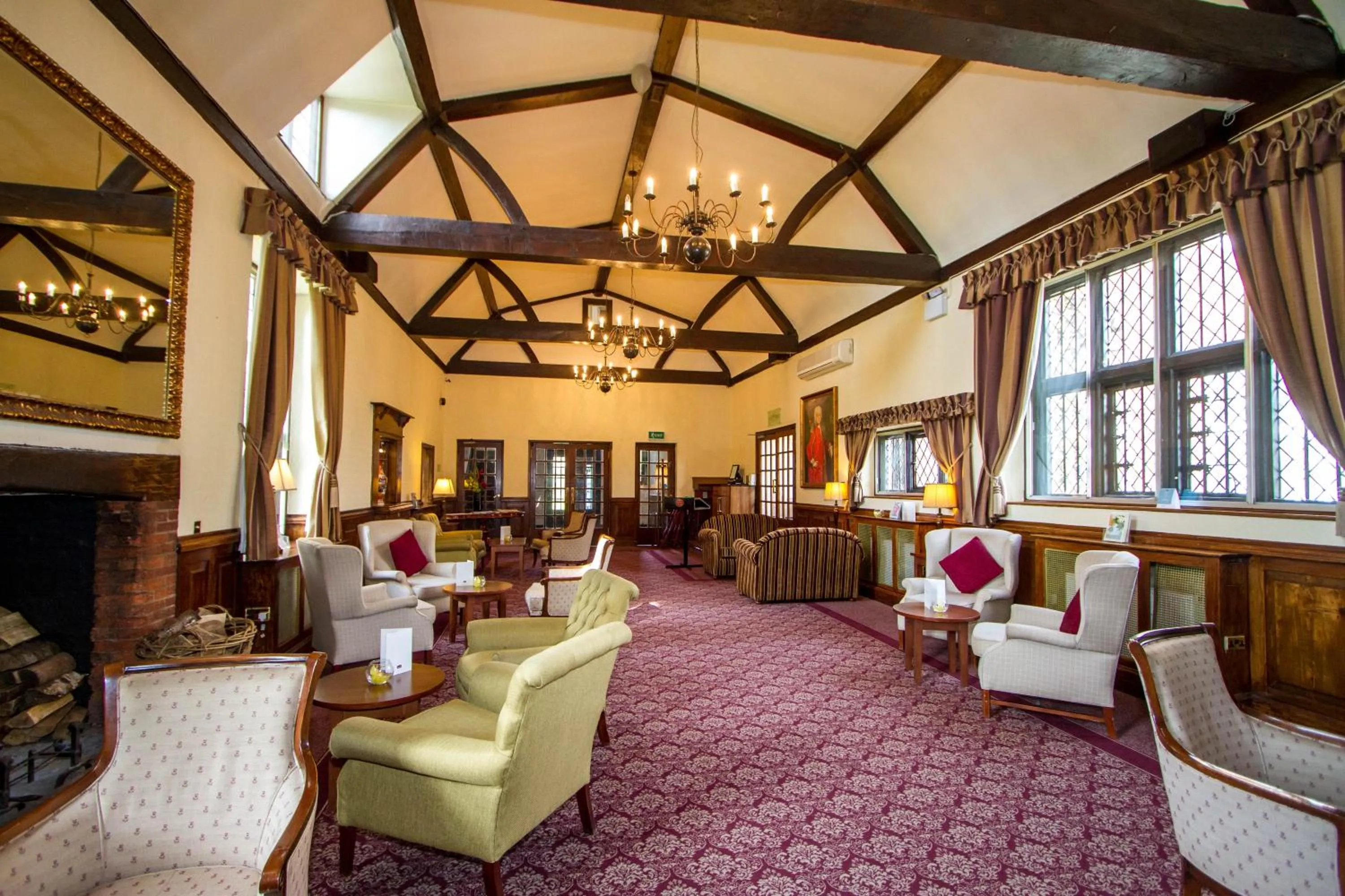 Communal lounge/ TV room in voco Letchworth Hall by IHG