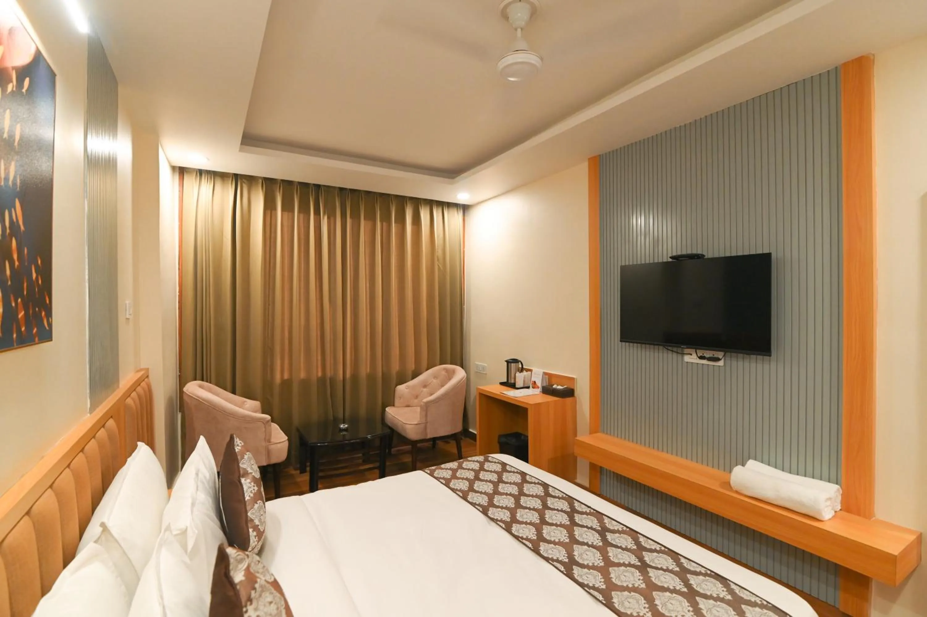 Seating area, Bed in Hotel Swagat Suites
