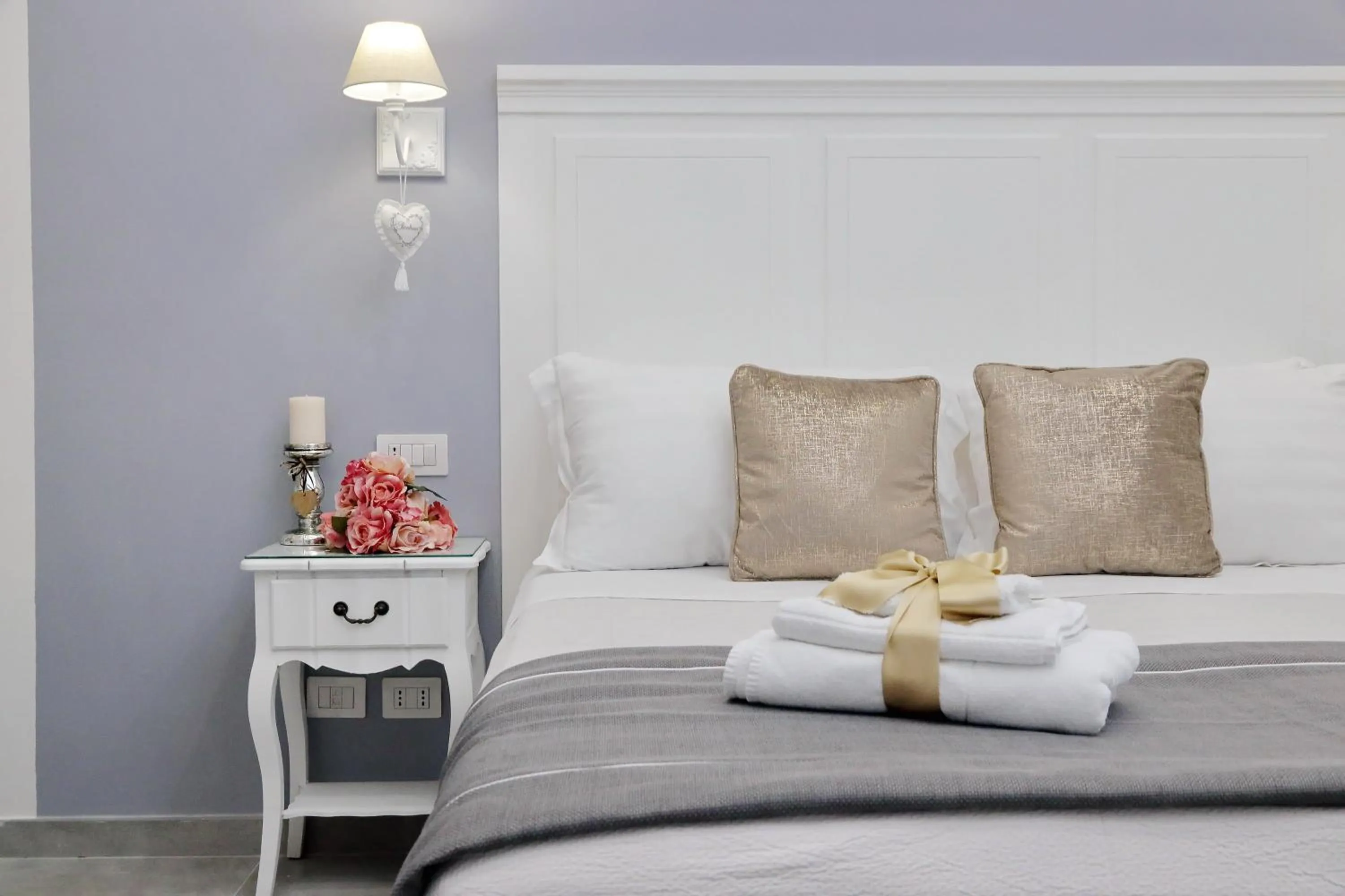 Bed in Roman Holiday Suites