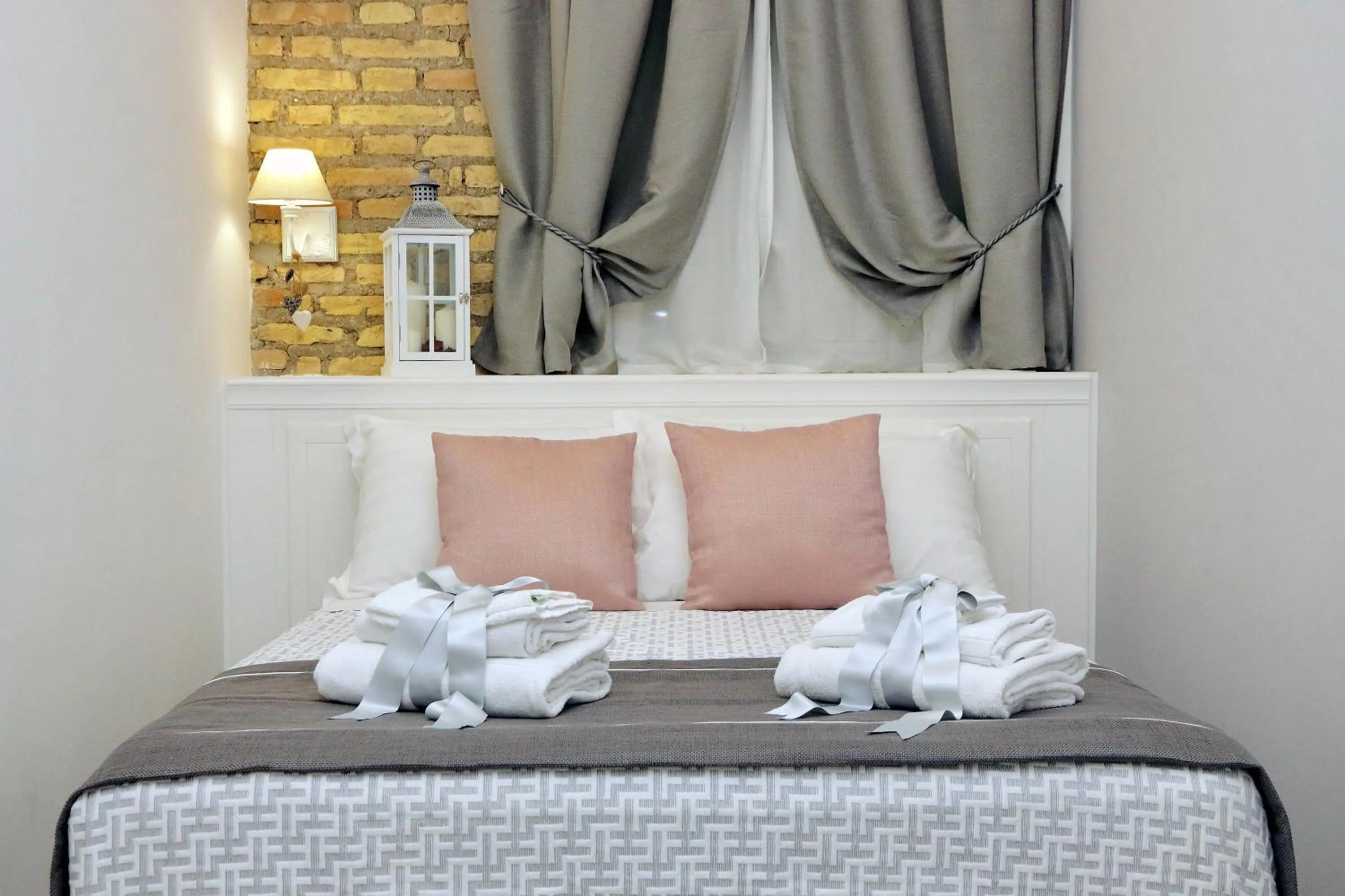 Bed in Roman Holiday Suites