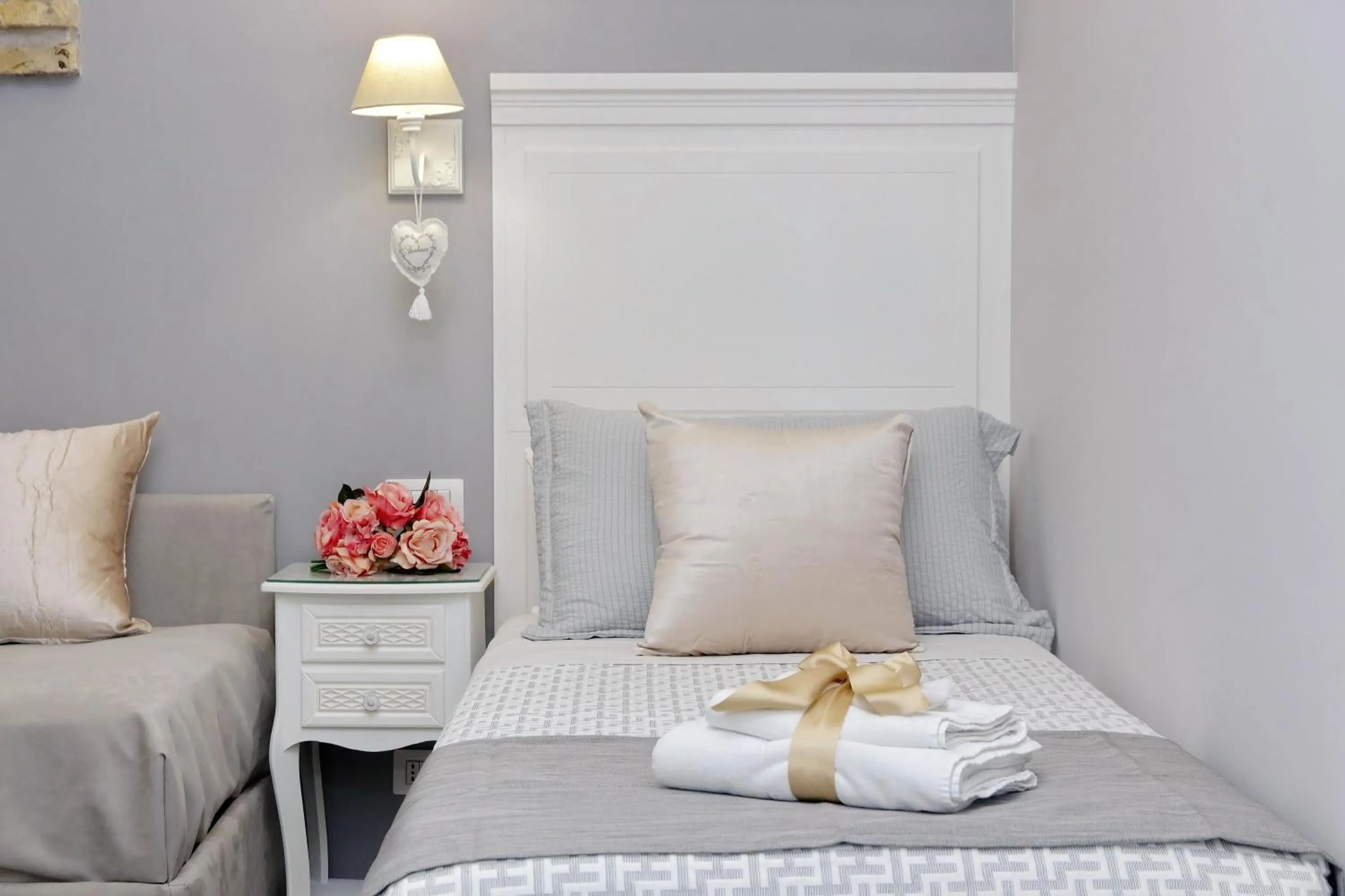 Bed in Roman Holiday Suites