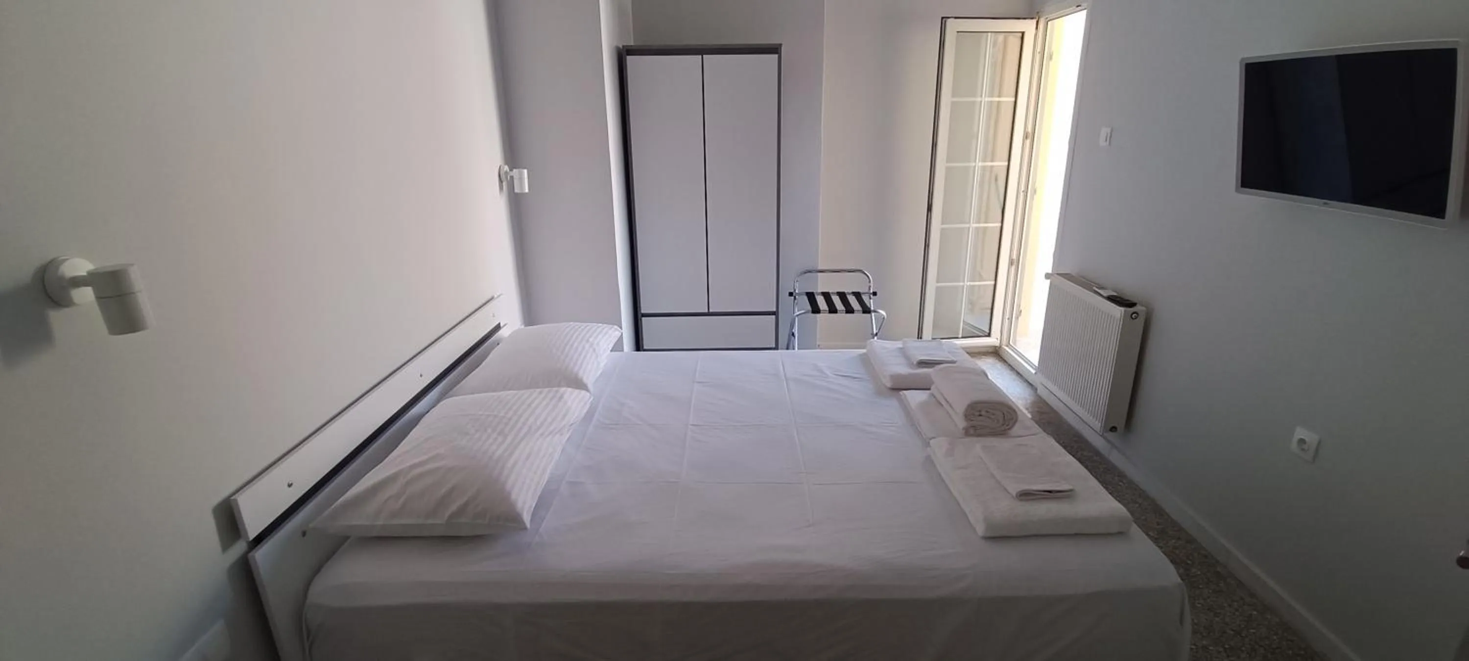 Bed in Artemis Plaza Suites