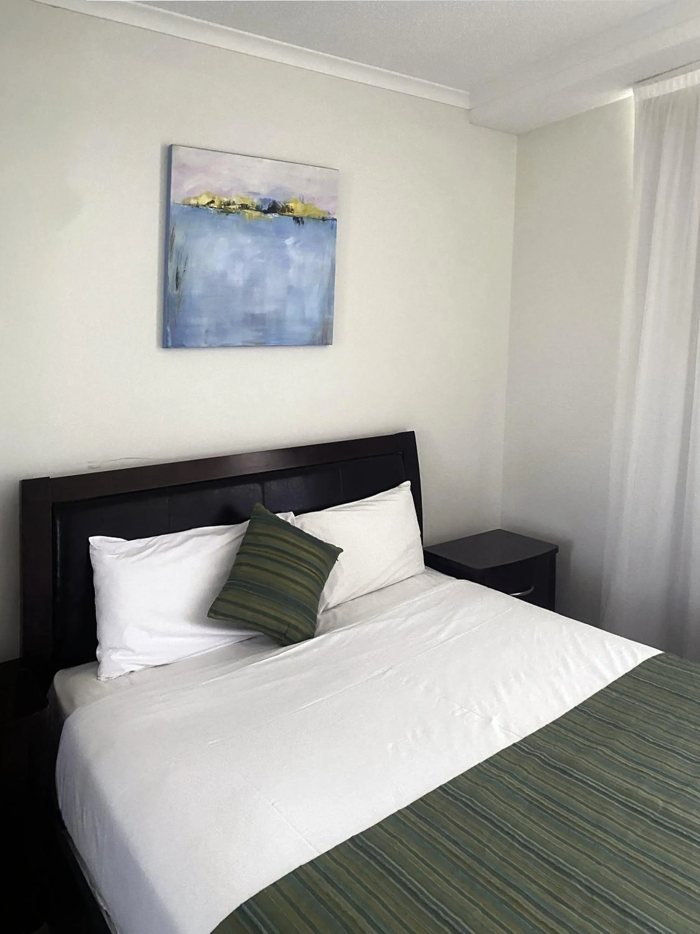 Bed in Curtis Central Apartments Official