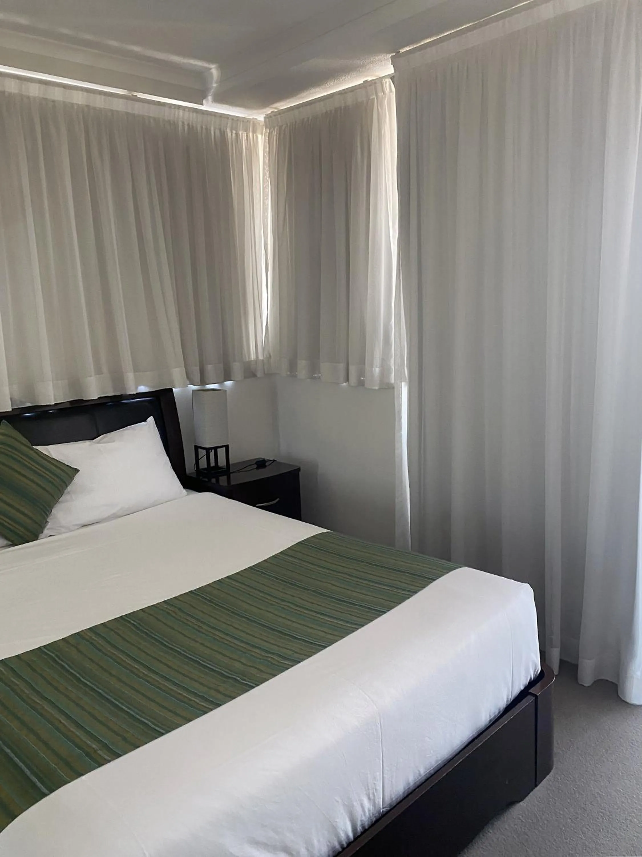 Bed in Curtis Central Apartments Official