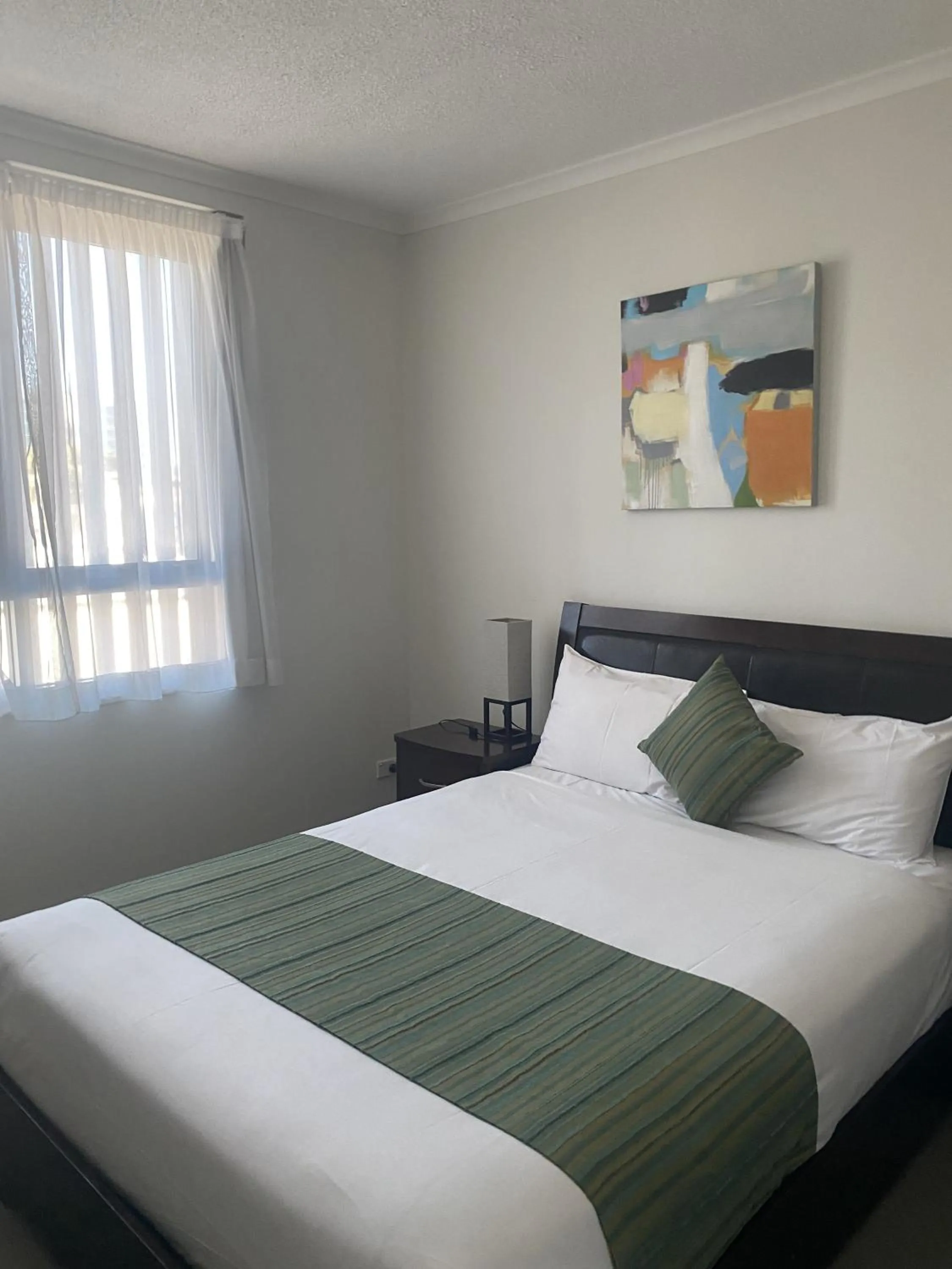 Bed in Curtis Central Apartments Official