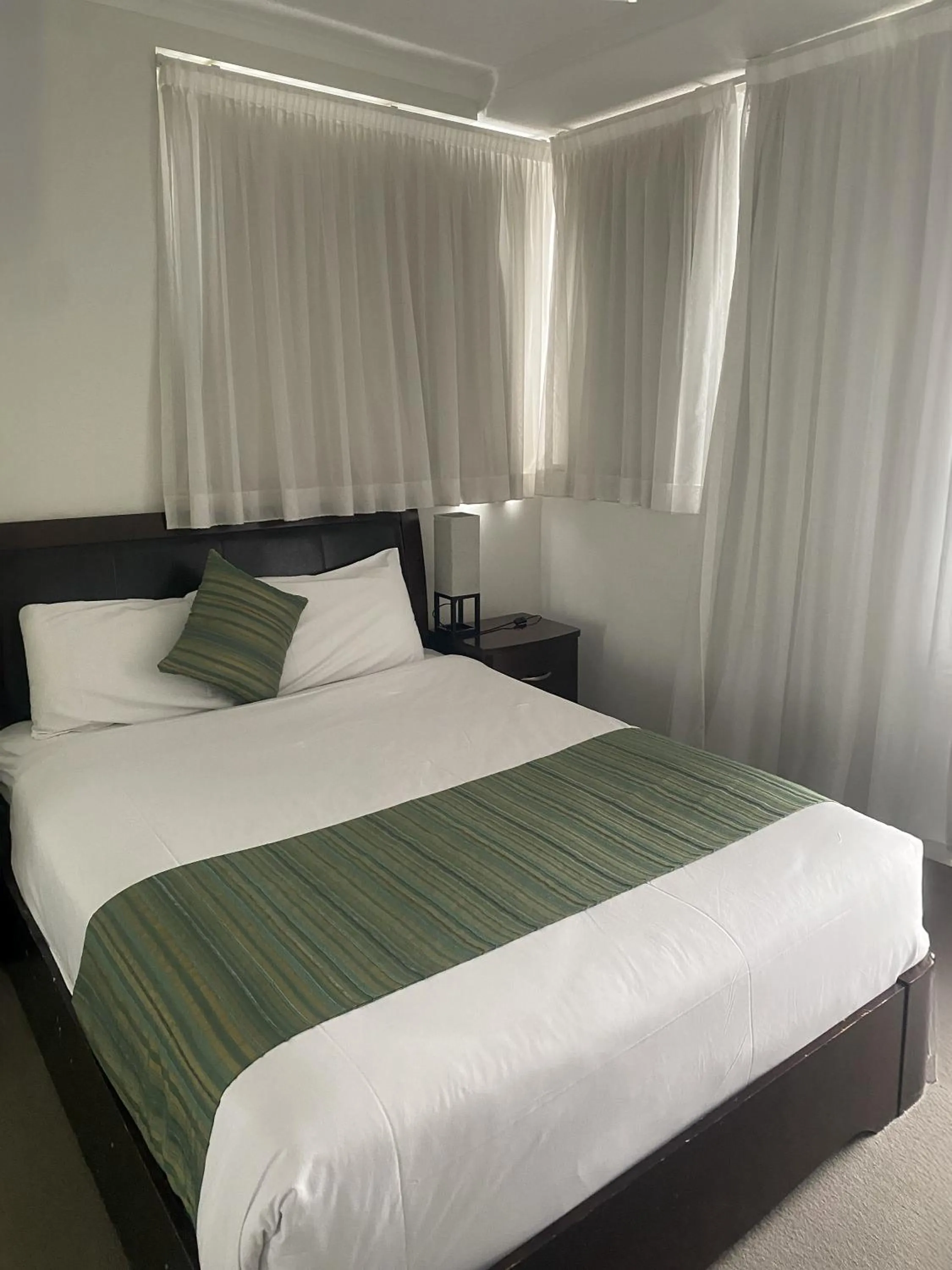 Bed in Curtis Central Apartments Official