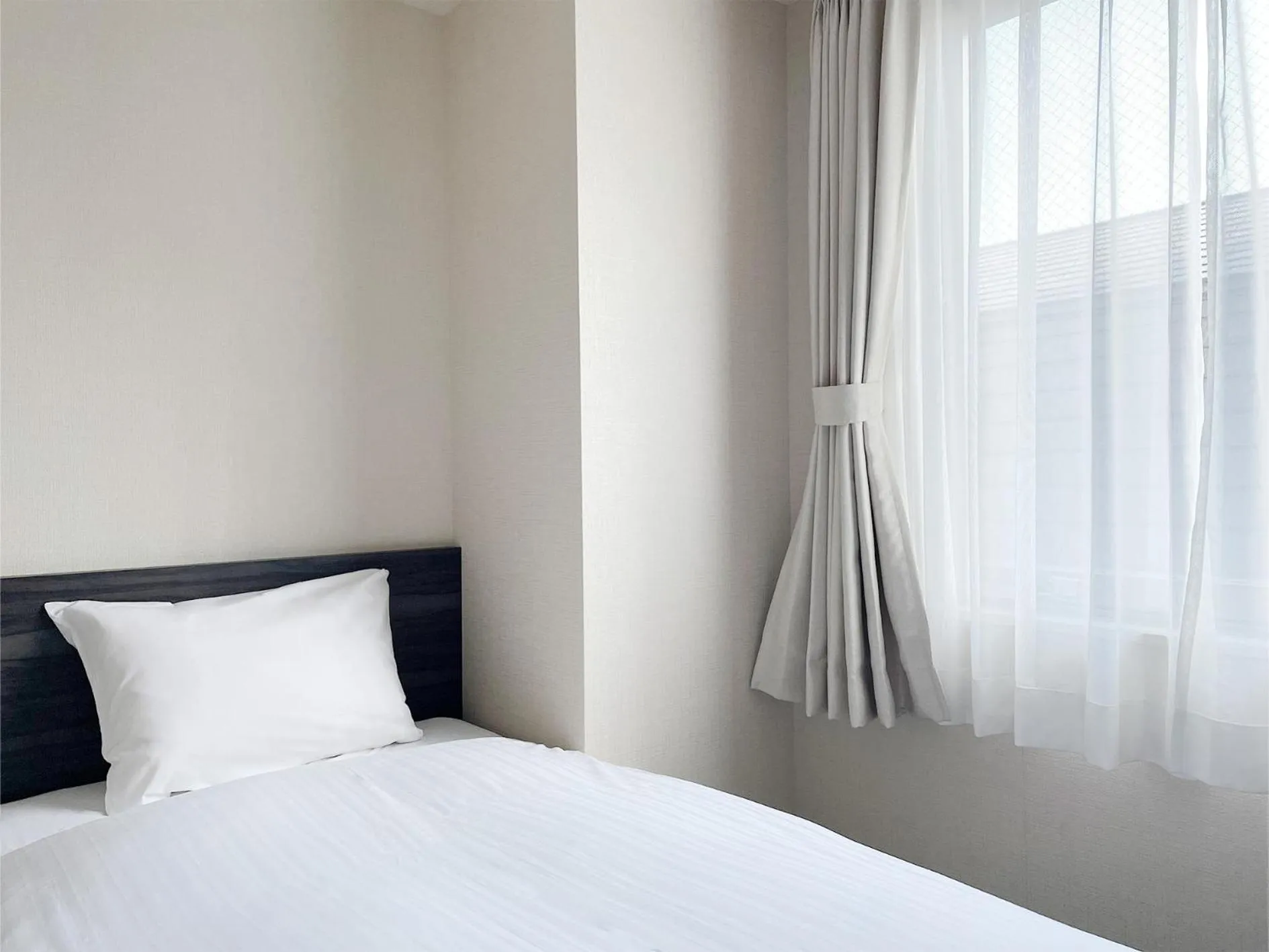 Bed in CHECKinn Osaka Shinimamiya