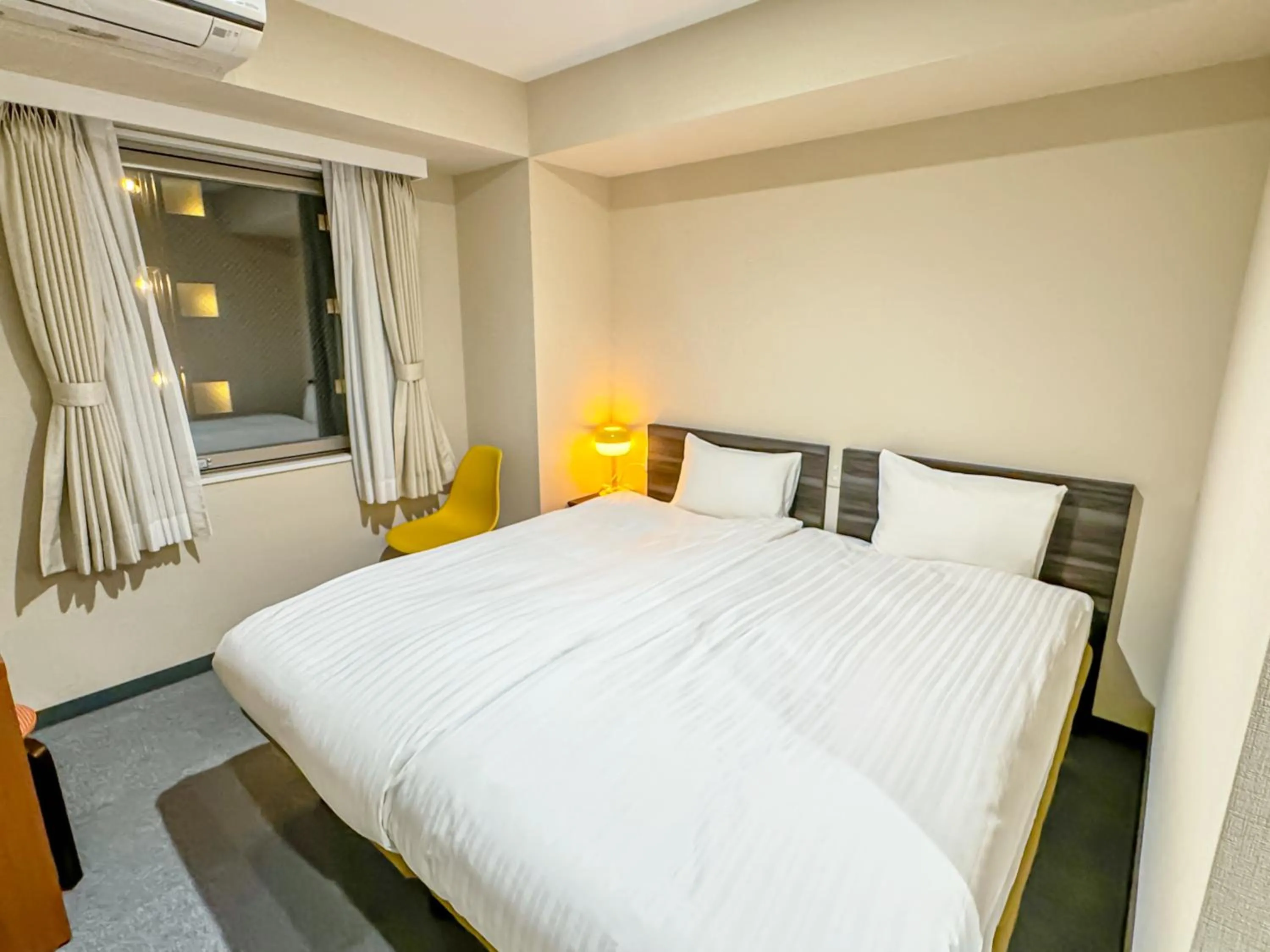 Bed in CHECKinn Osaka Shinimamiya