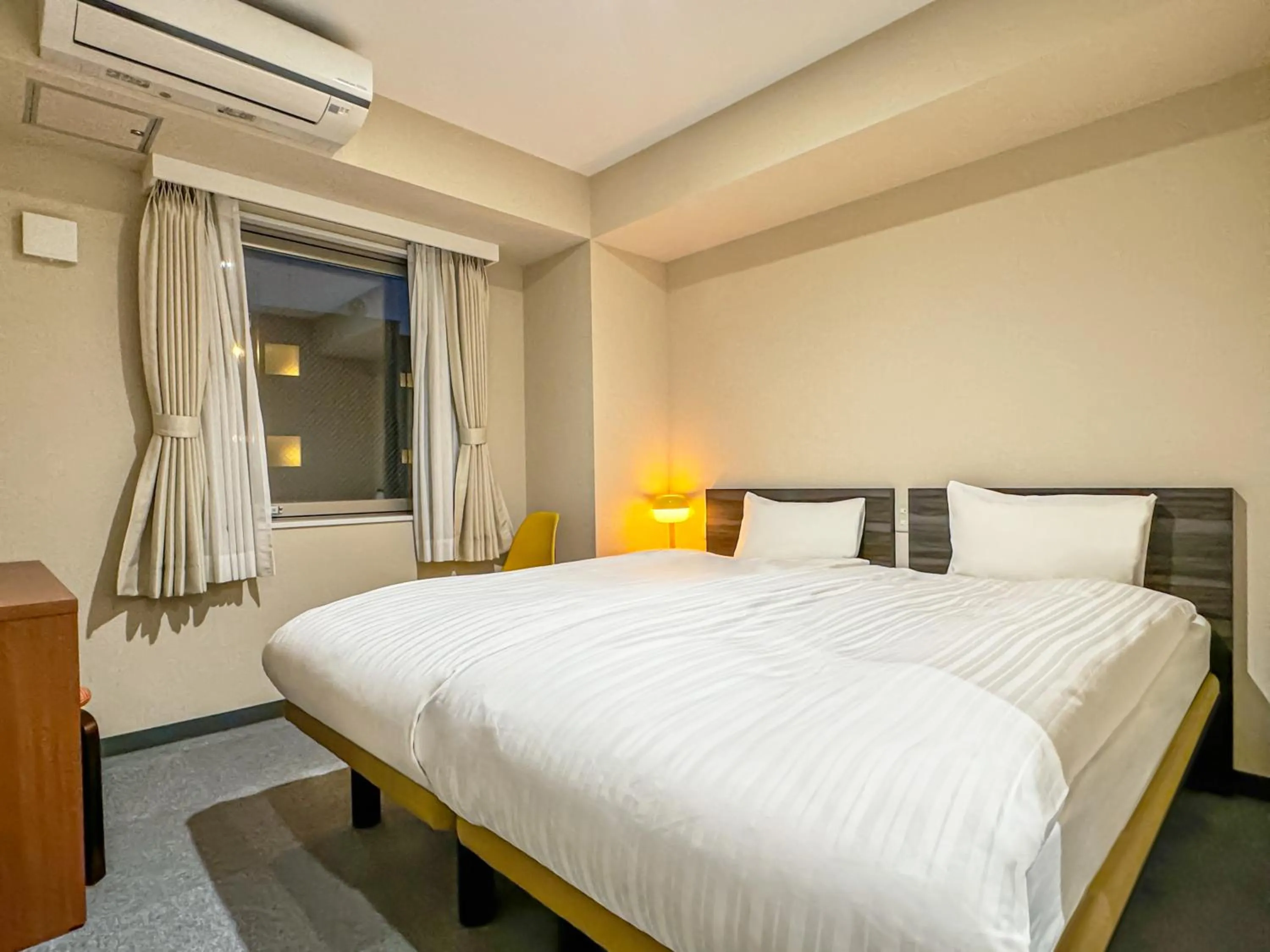 Bed in CHECKinn Osaka Shinimamiya