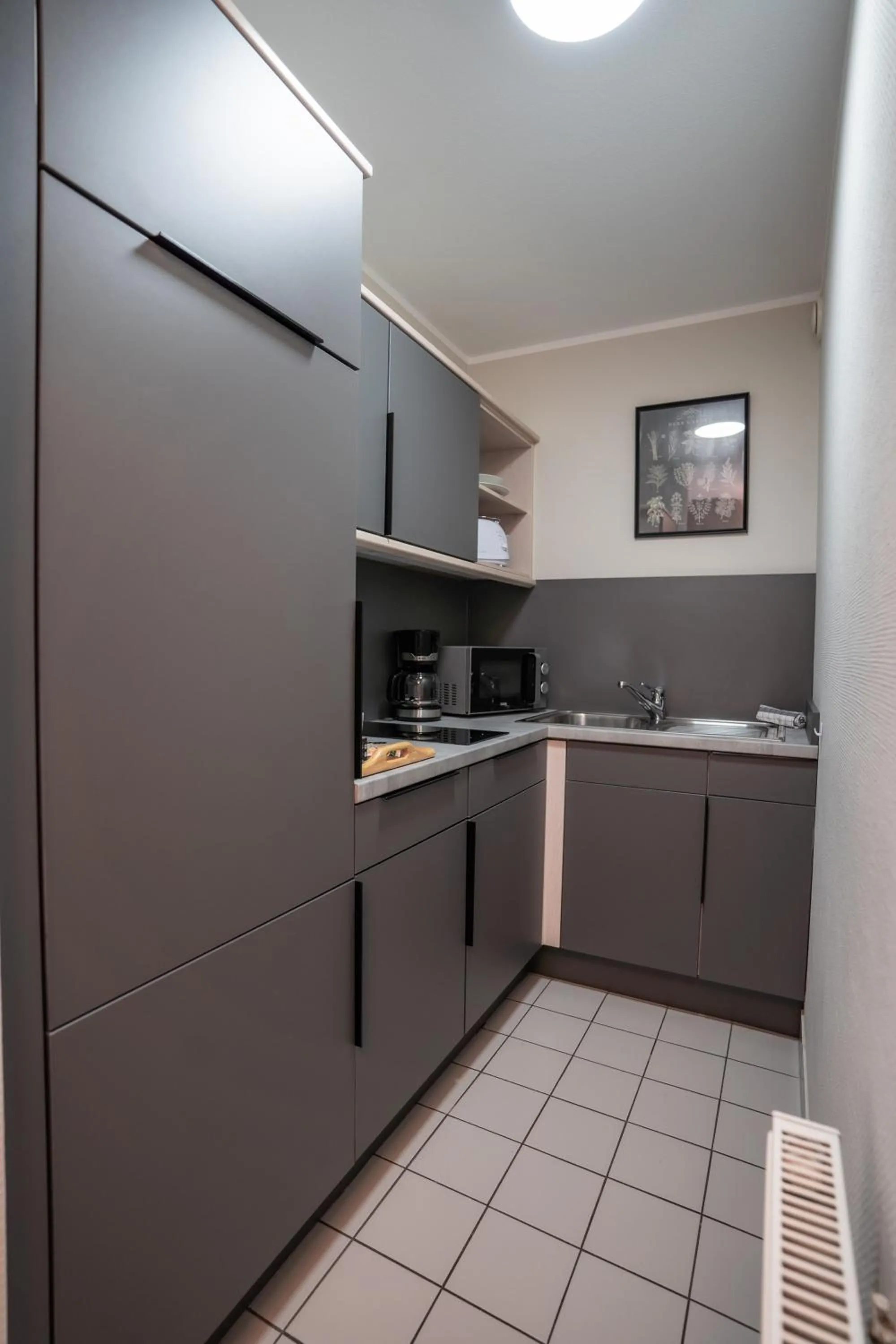 Kitchen or kitchenette in Hotel CityHome am Kurpark