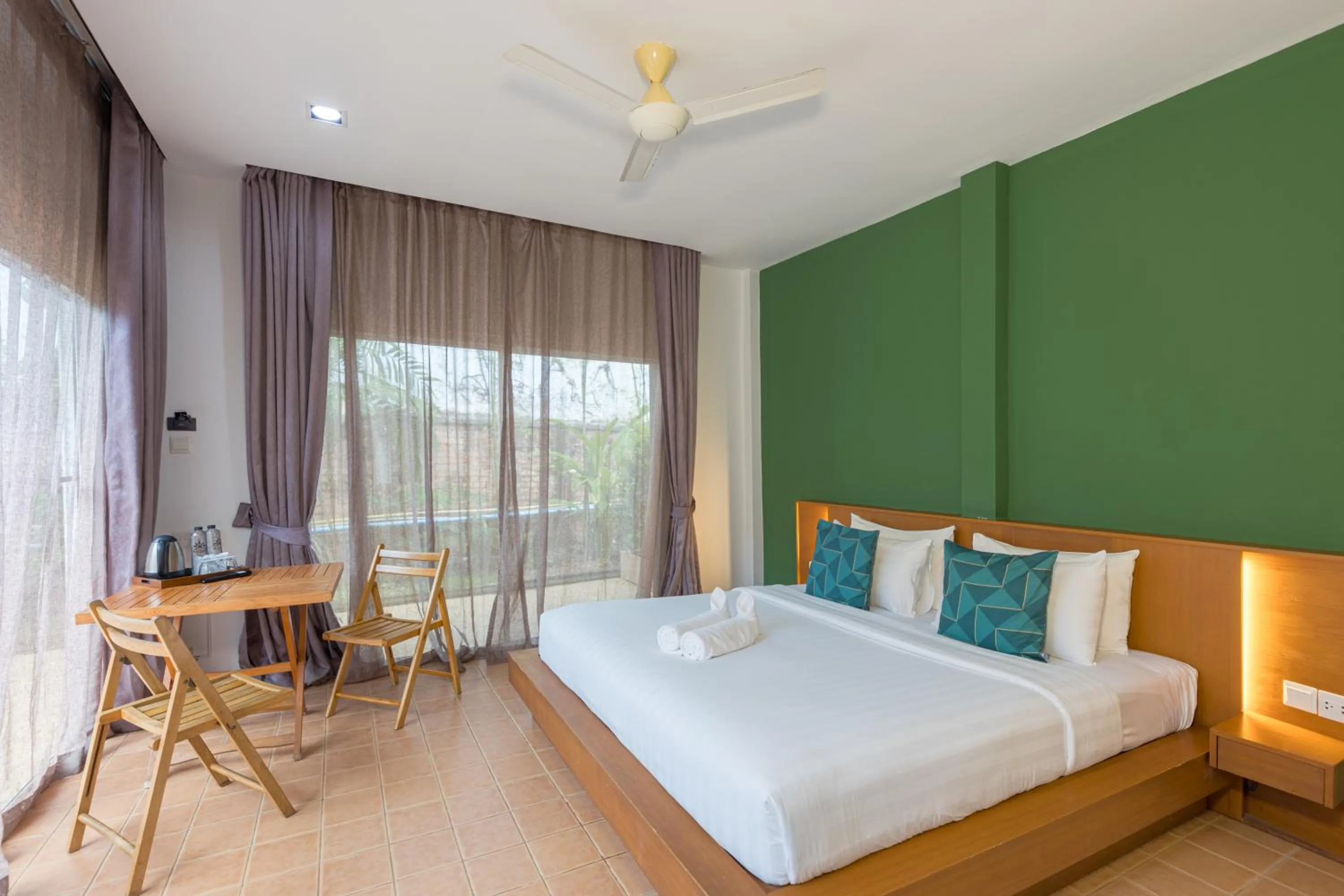 Seating area, Bed in Blue Palm Kata Resort