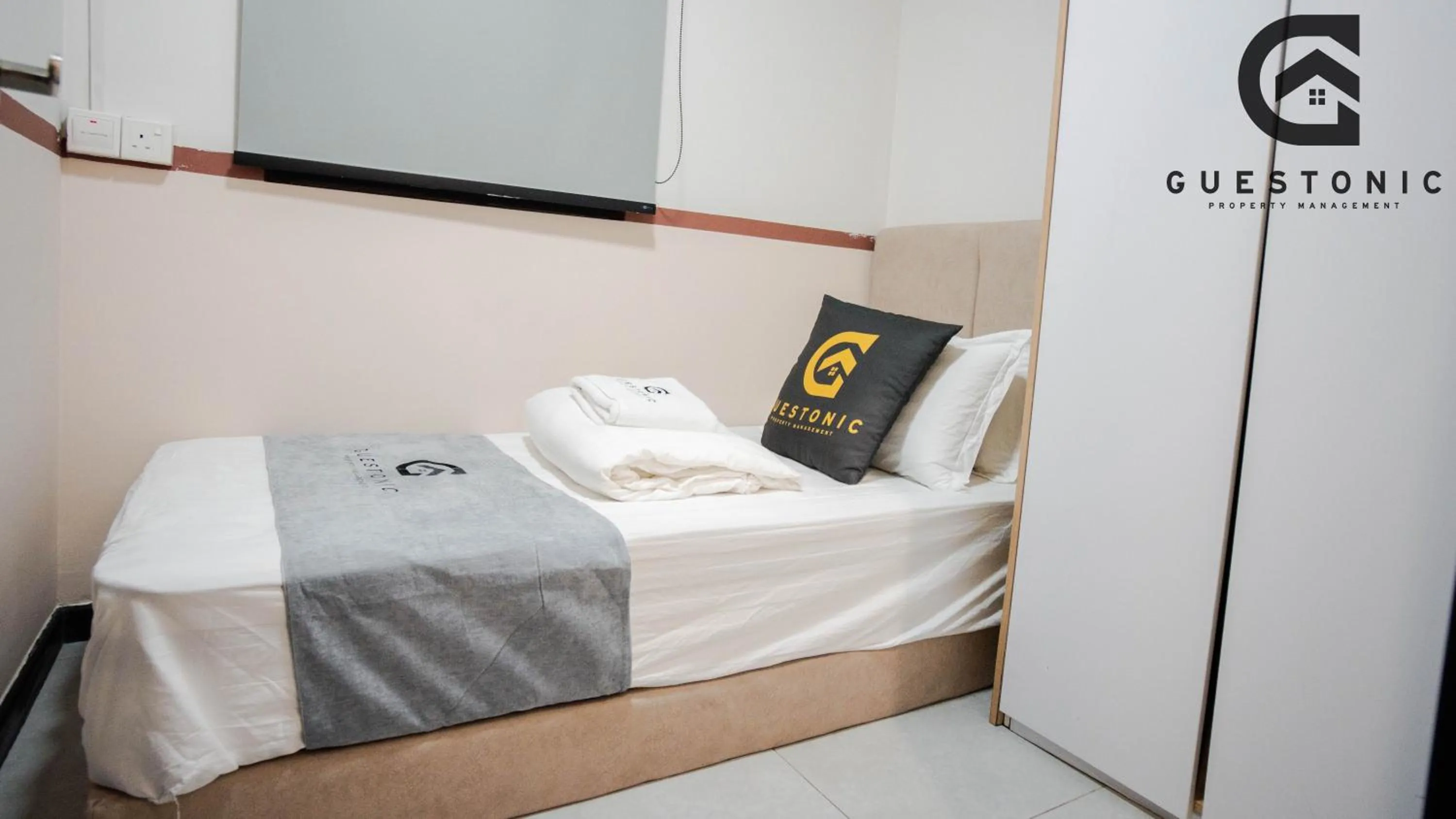 Bed in NeuSuite Cozy Studio by GUESTONIC