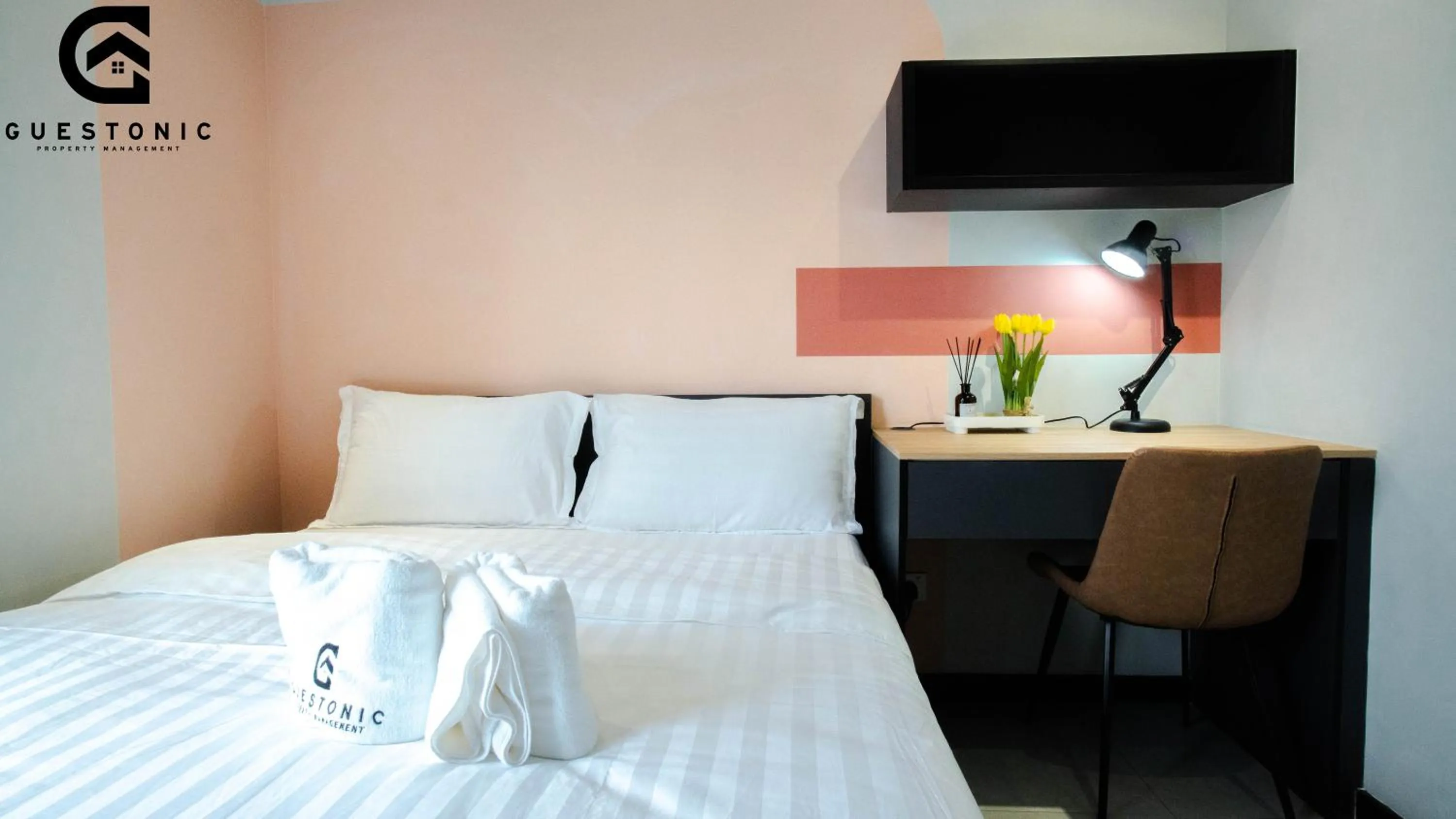 Bed in NeuSuite Cozy Studio by GUESTONIC