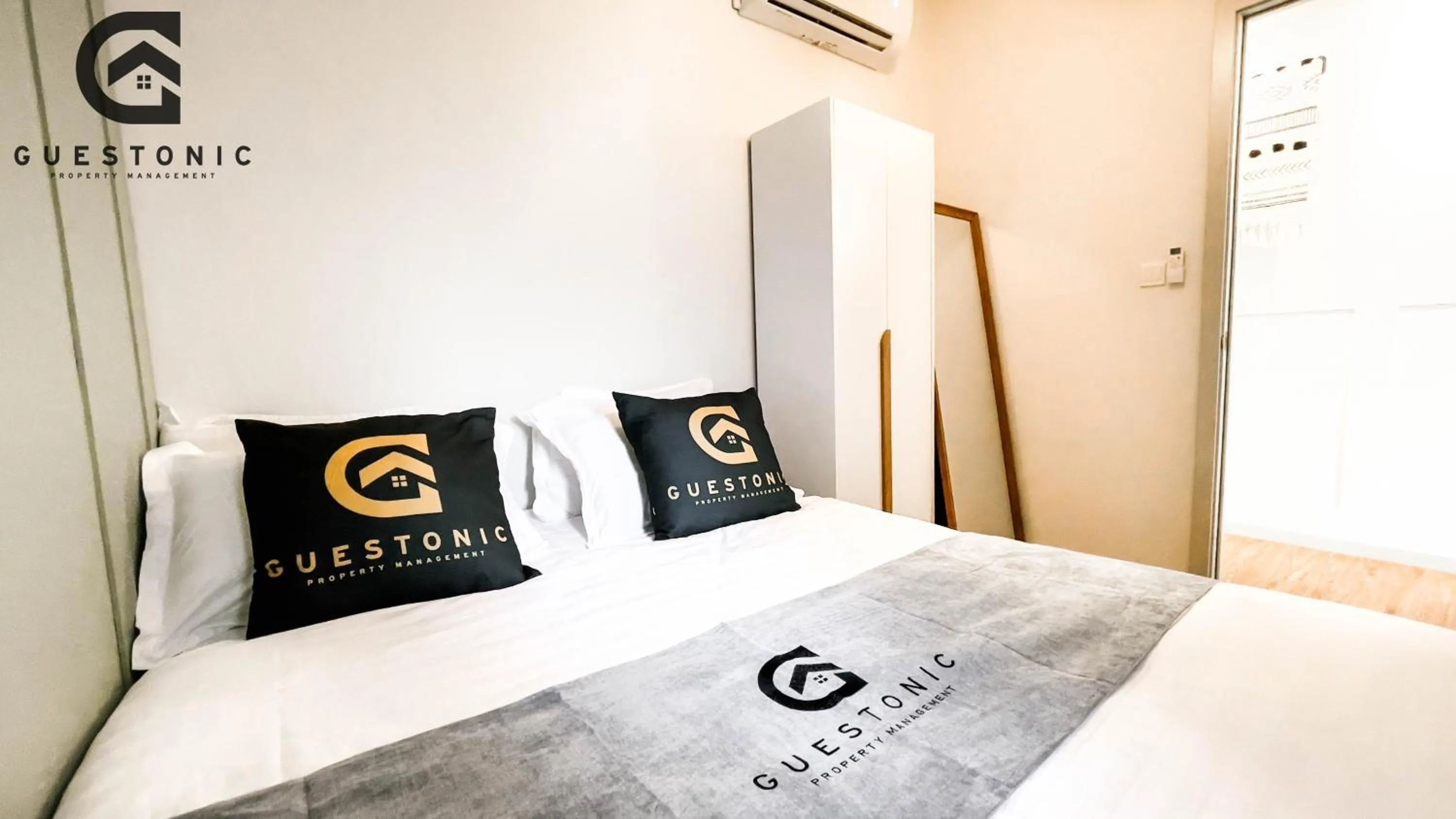 Bed in NeuSuite Cozy Studio by GUESTONIC