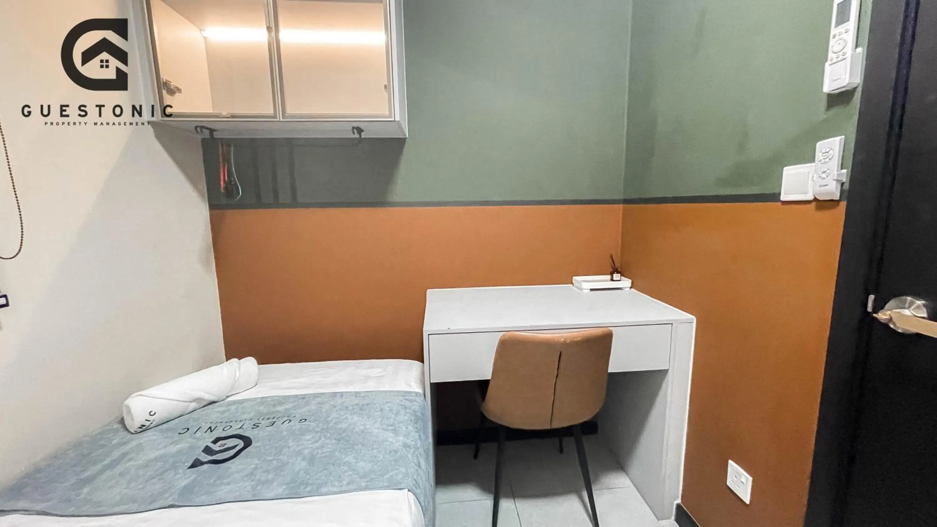 Bed in NeuSuite Cozy Studio by GUESTONIC