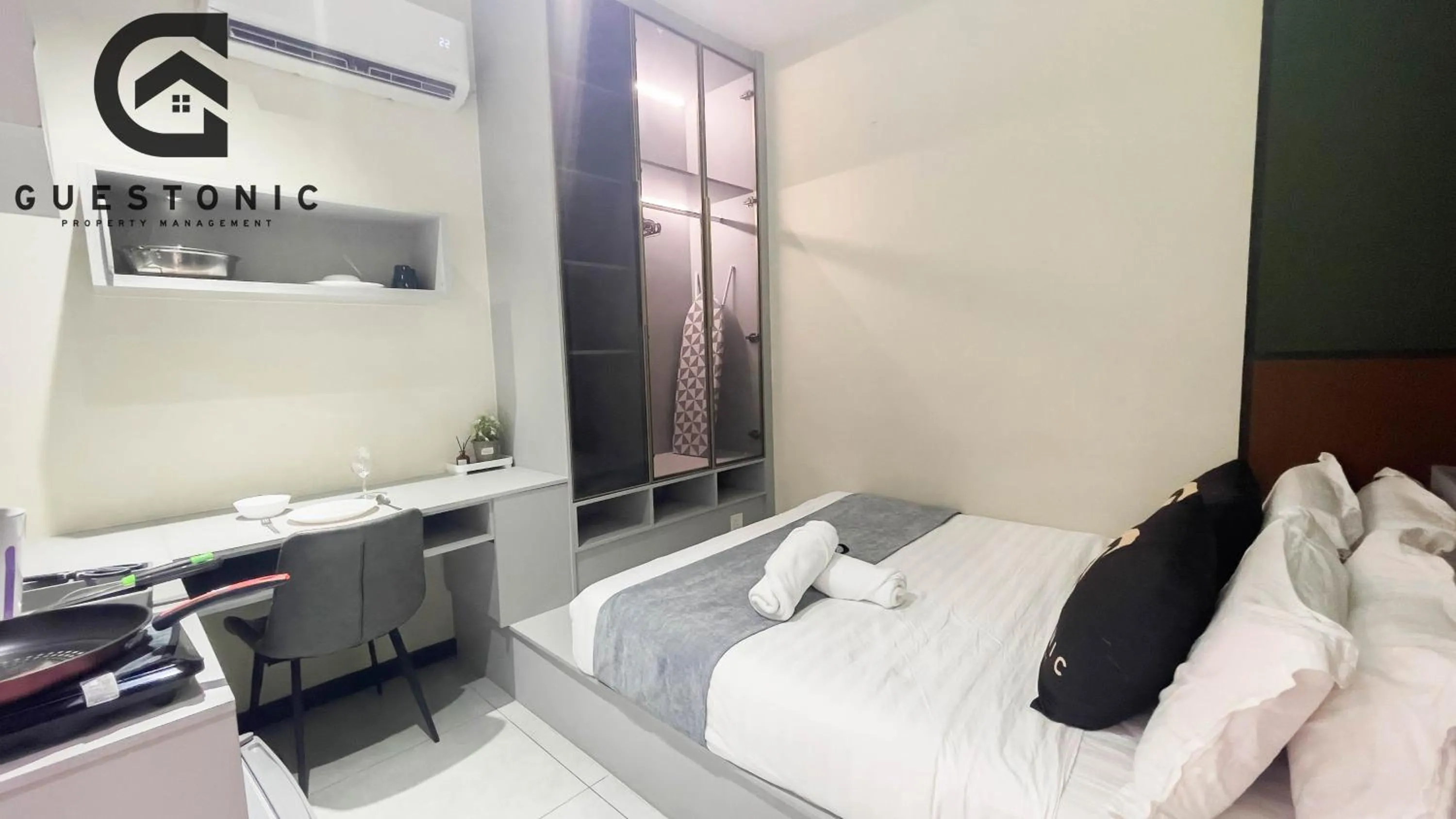 Bed in NeuSuite Cozy Studio by GUESTONIC