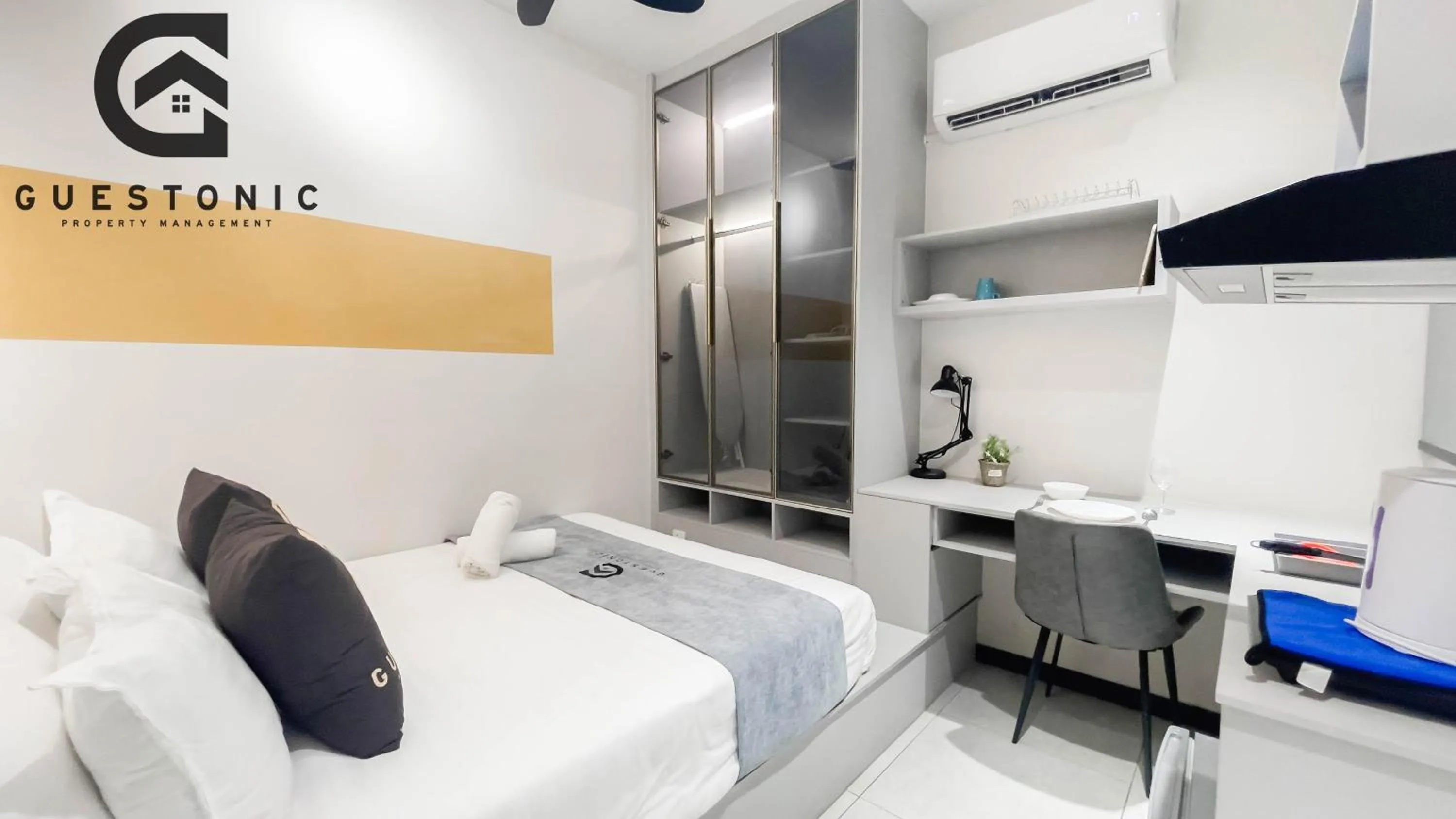 Bed in NeuSuite Cozy Studio by GUESTONIC