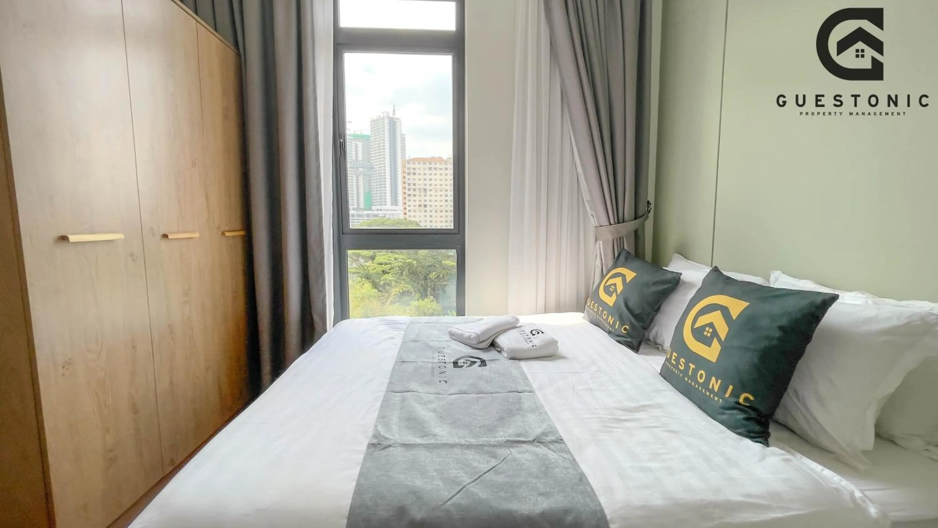 Bed in NeuSuite Cozy Studio by GUESTONIC