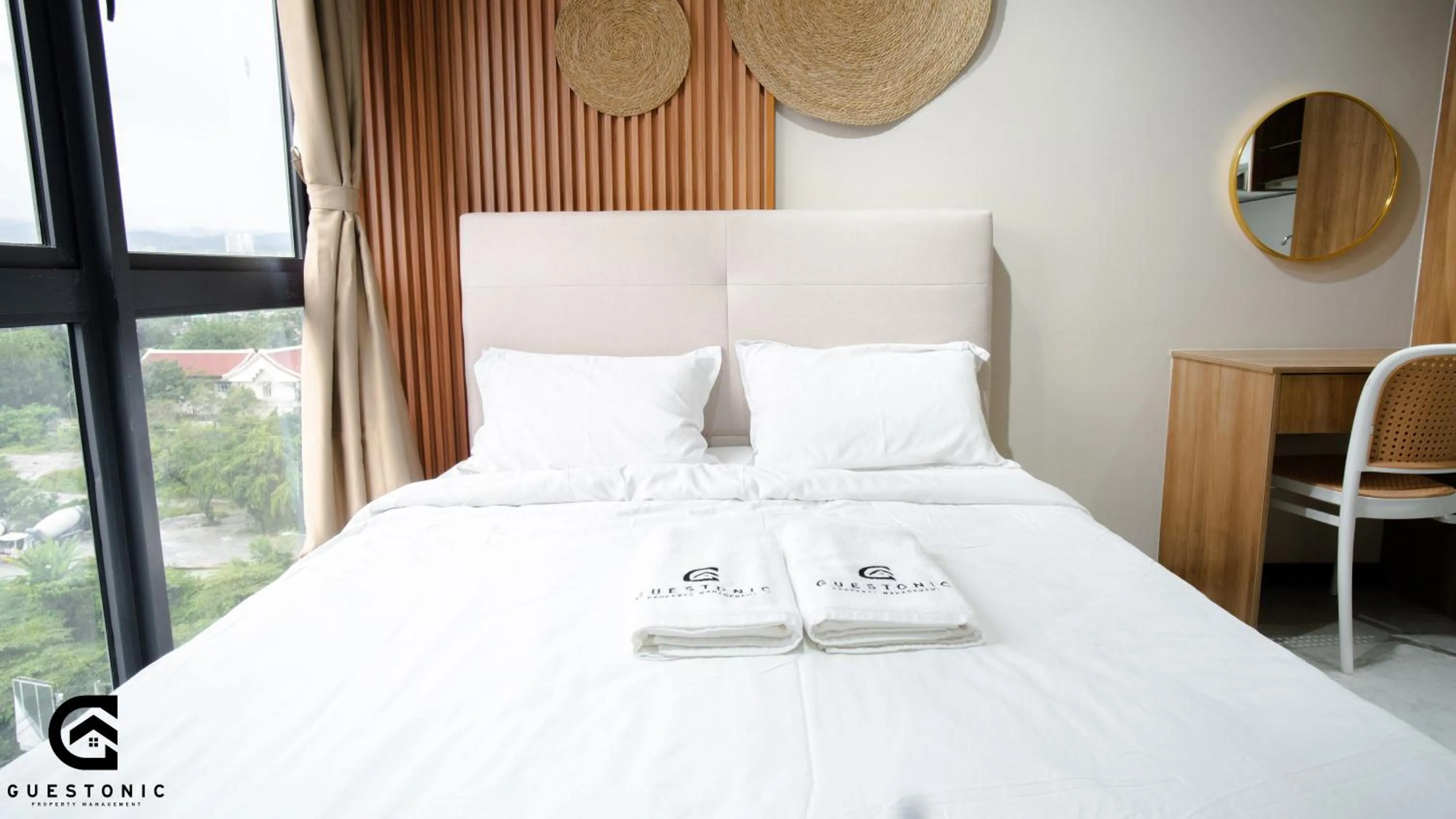 Bed in NeuSuite Cozy Studio by GUESTONIC