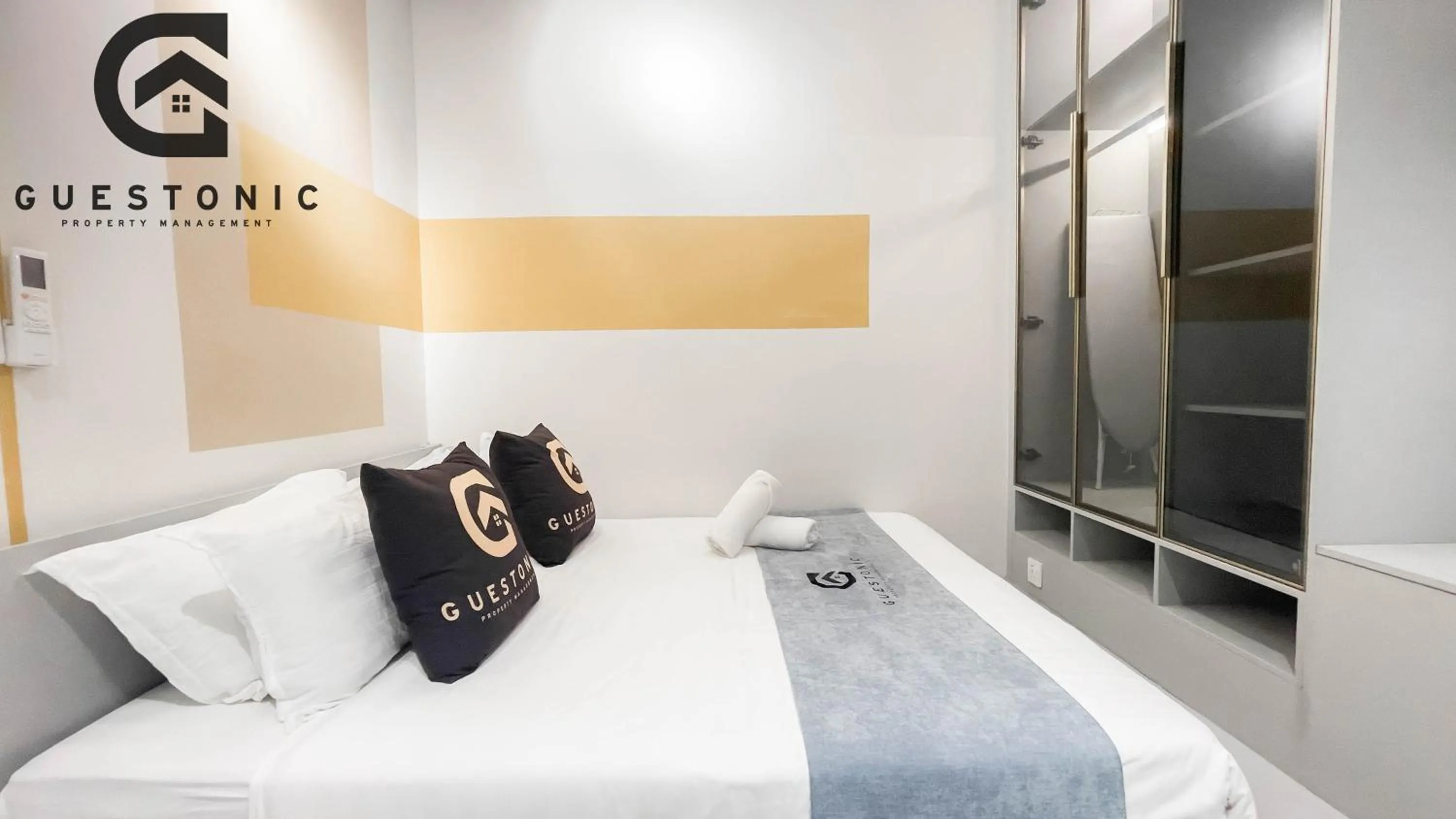 Bed in NeuSuite Cozy Studio by GUESTONIC