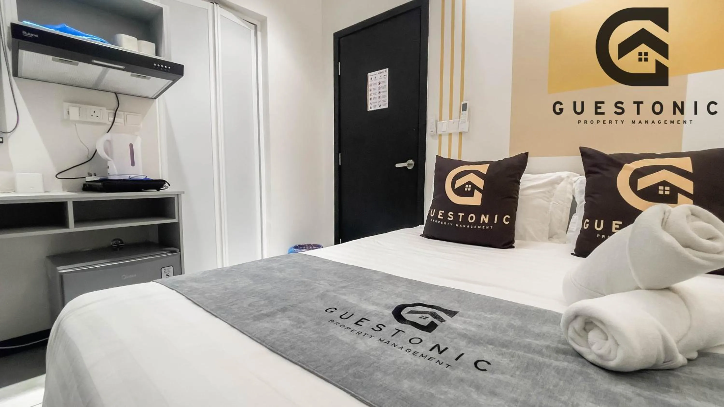 Bed in NeuSuite Cozy Studio by GUESTONIC