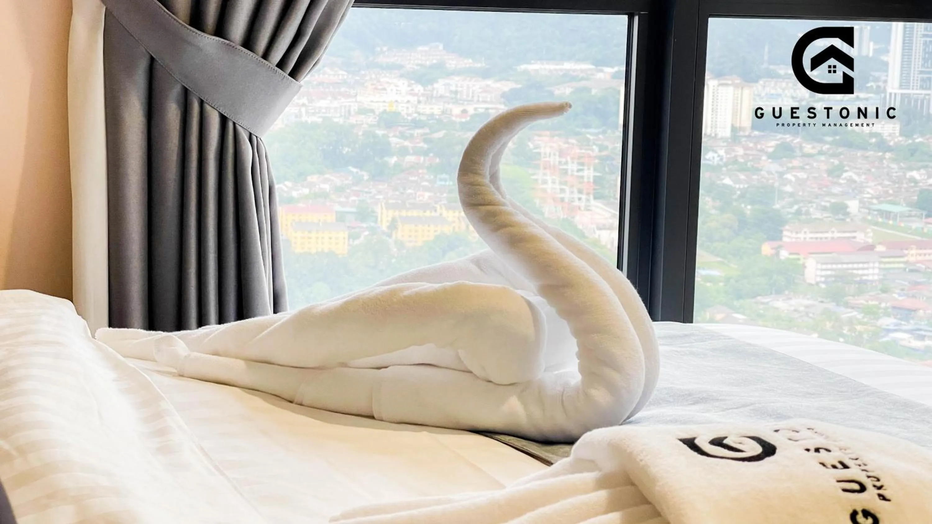 Bed in NeuSuite Cozy Studio by GUESTONIC