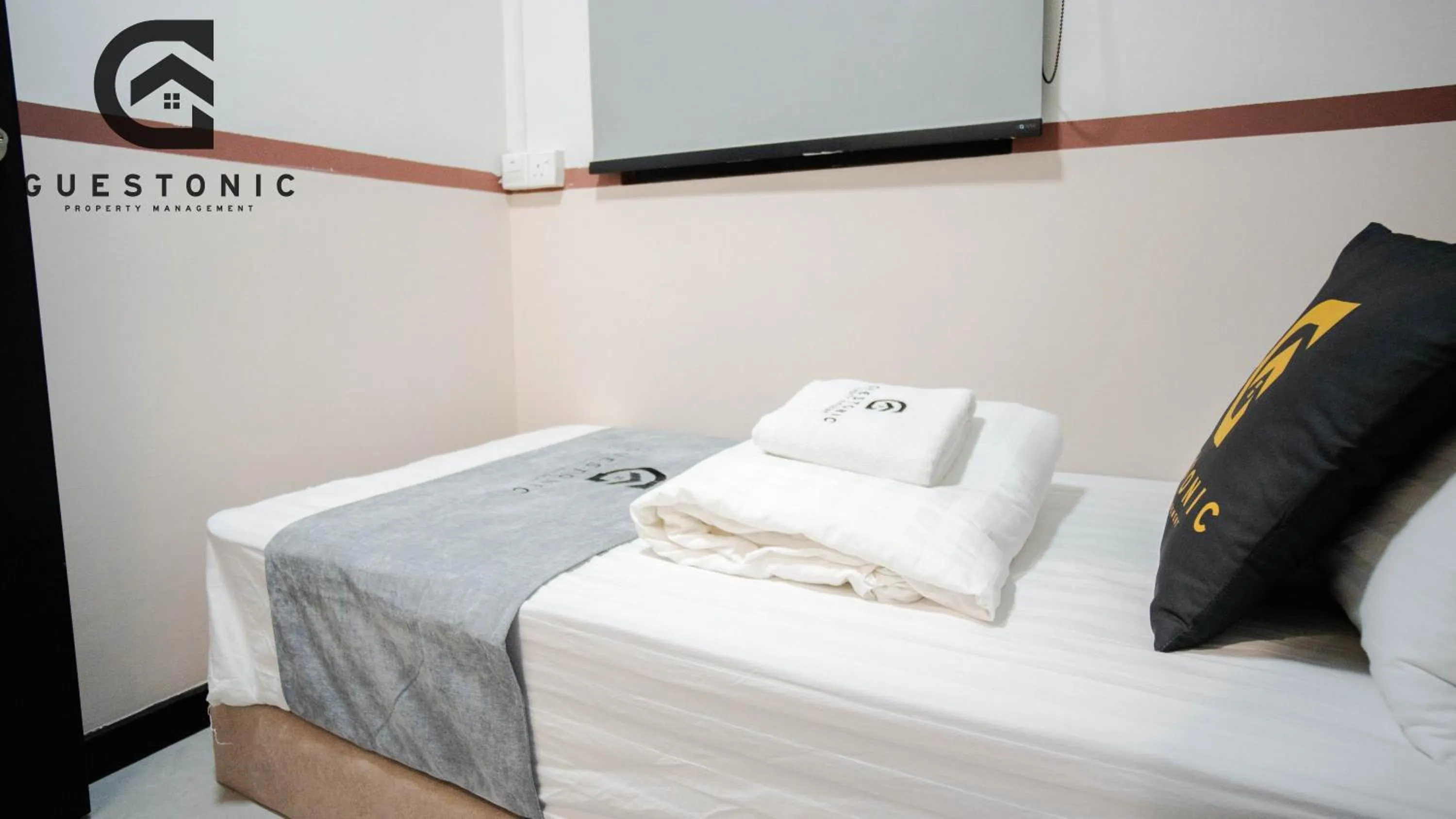 Bed in NeuSuite Cozy Studio by GUESTONIC