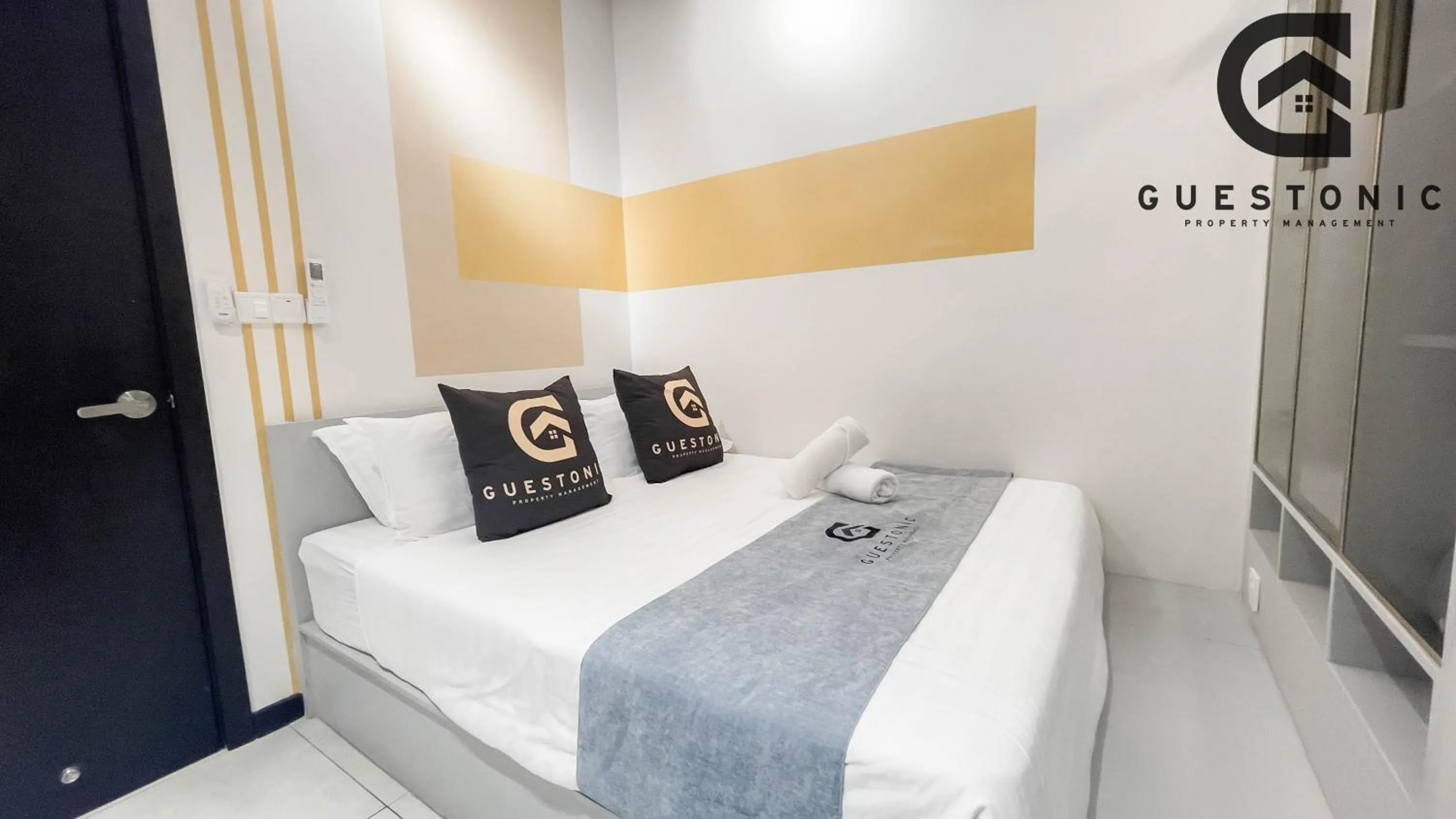 Bed in NeuSuite Cozy Studio by GUESTONIC