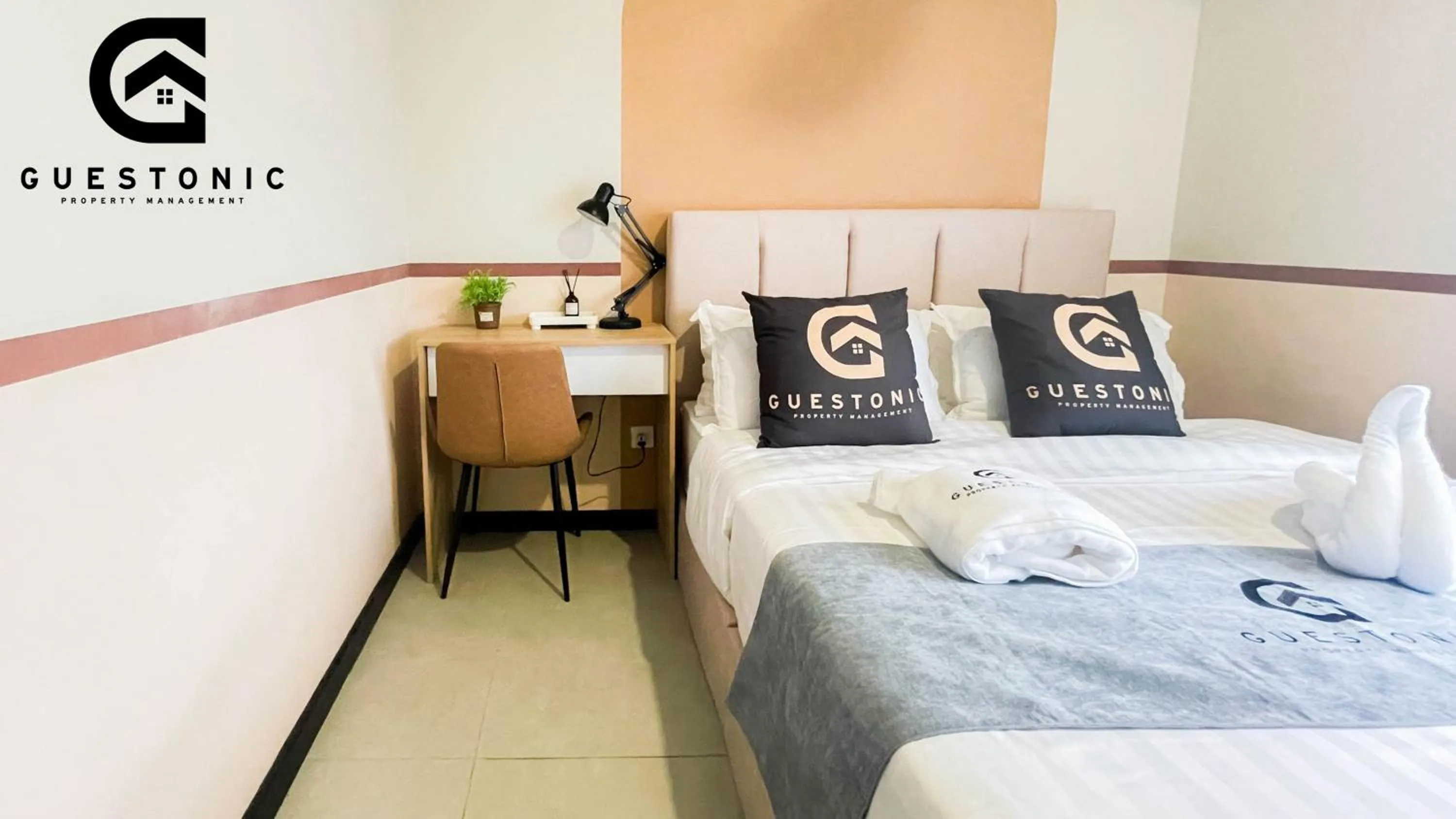 Bed in NeuSuite Cozy Studio by GUESTONIC