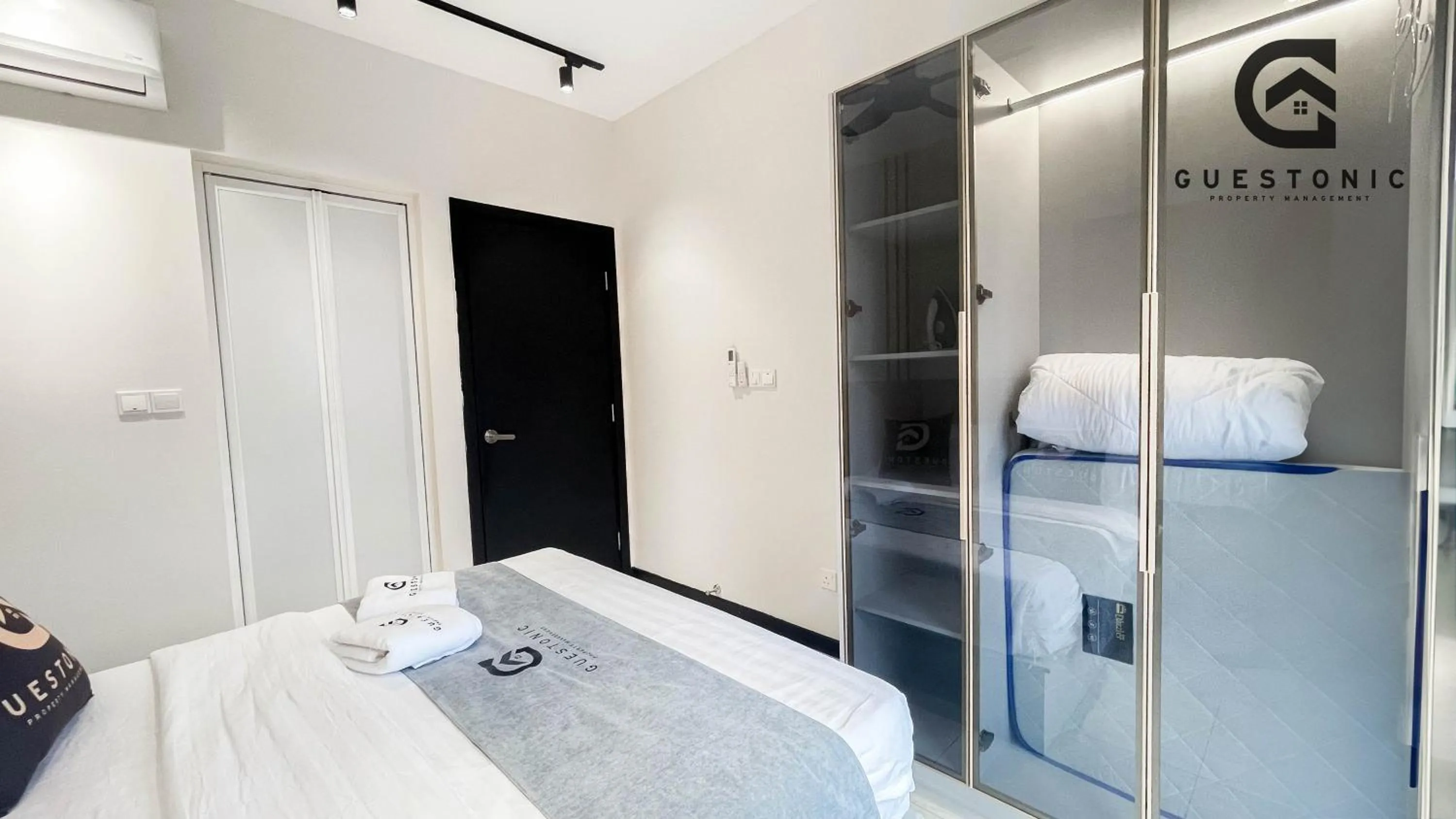 Bed in NeuSuite Cozy Studio by GUESTONIC