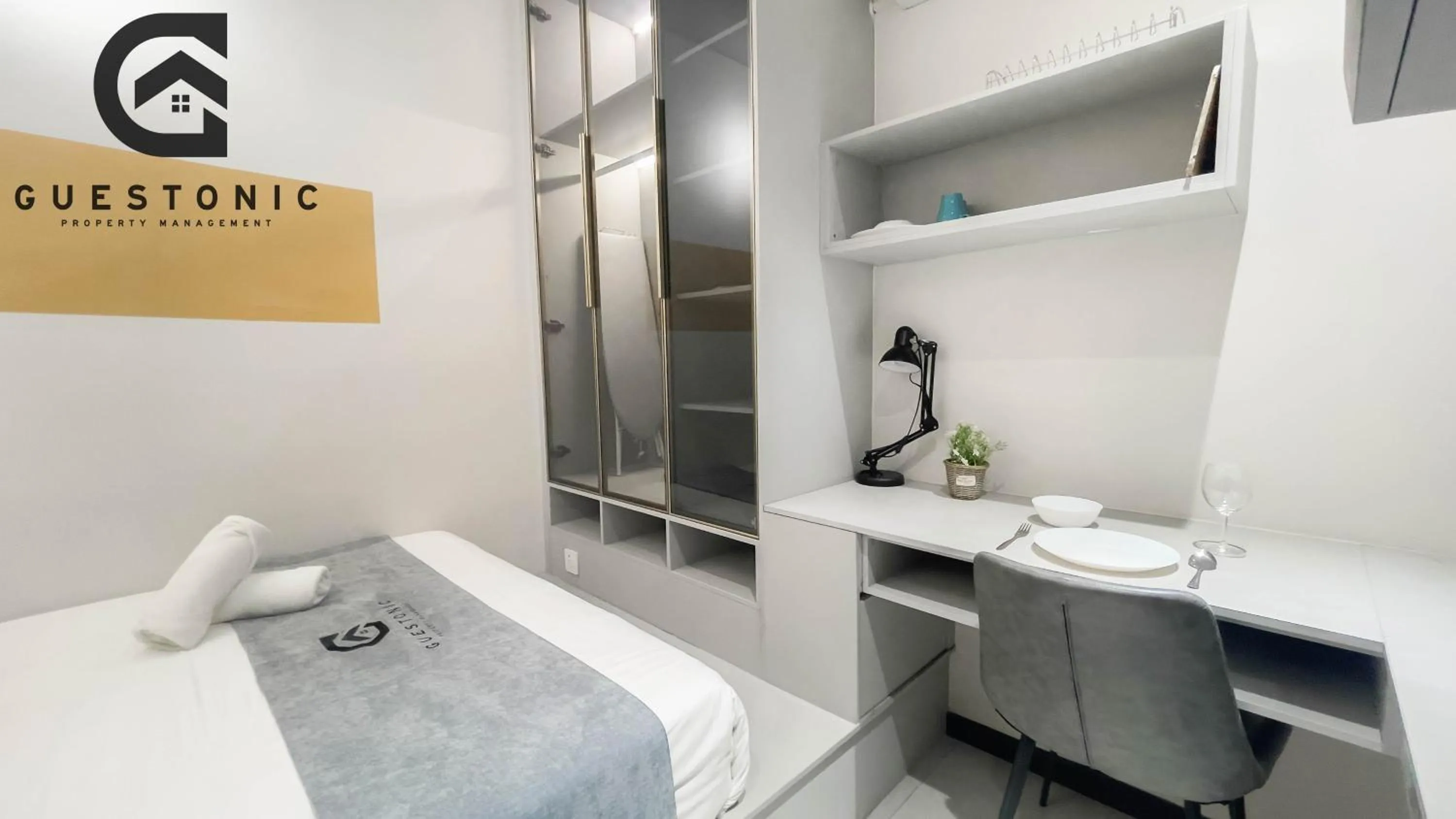 Bed in NeuSuite Cozy Studio by GUESTONIC