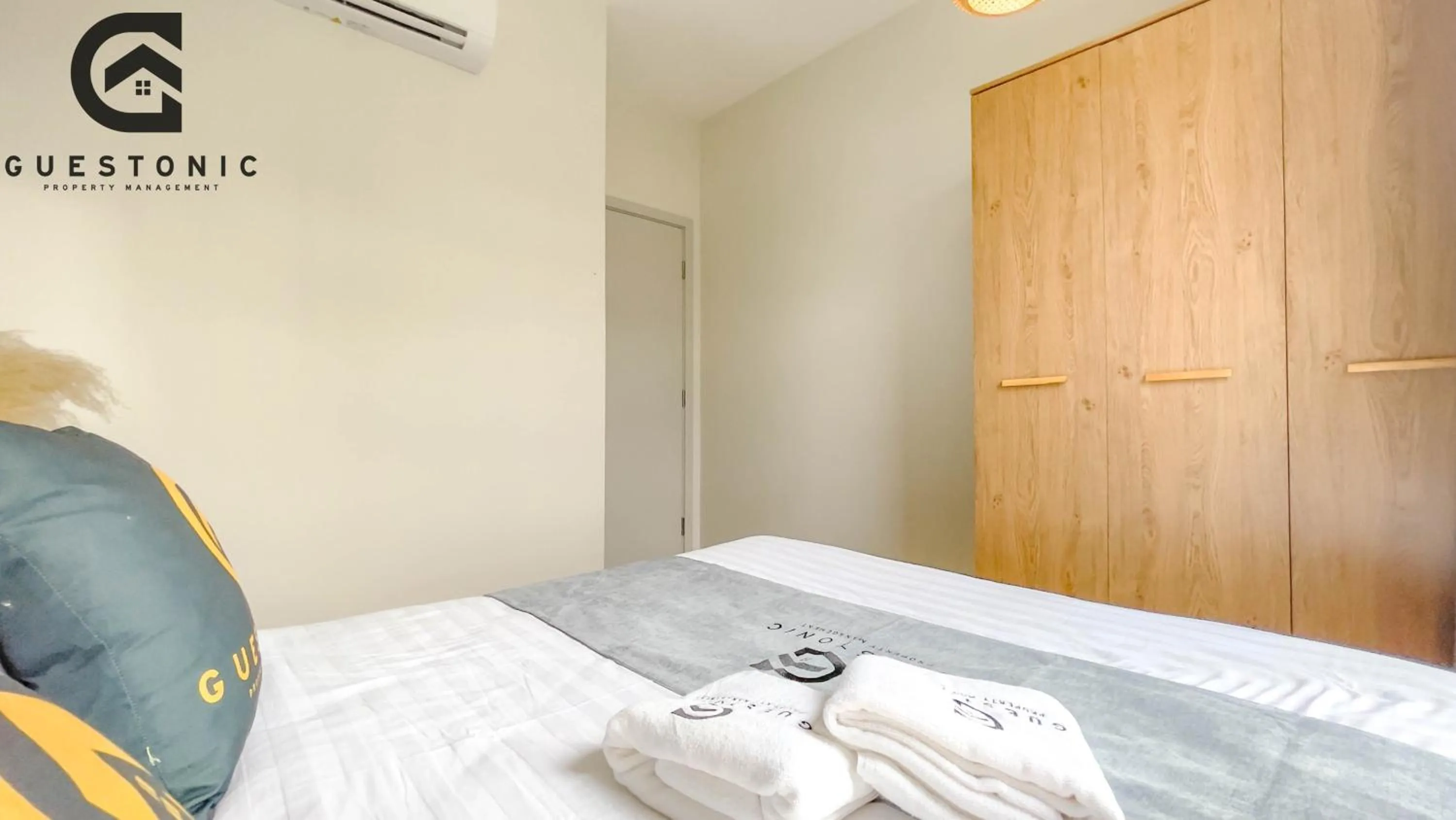 Bed in NeuSuite Cozy Studio by GUESTONIC