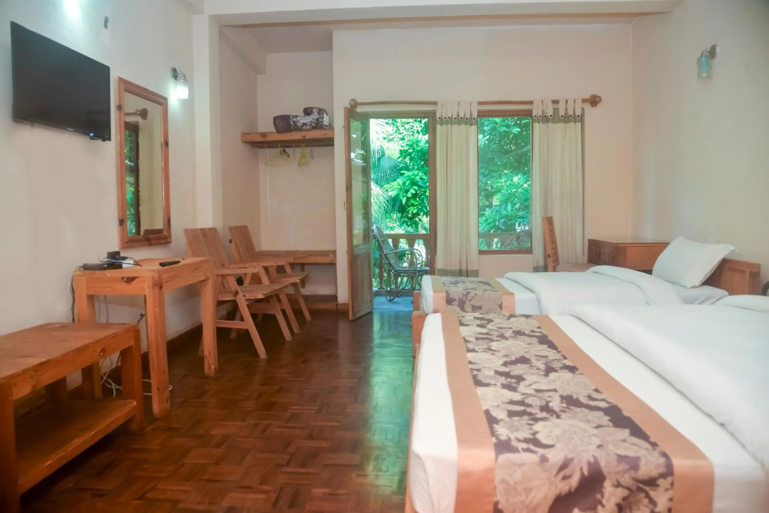 Photo of the whole room, Bed in Chitwan Paradise Hotel